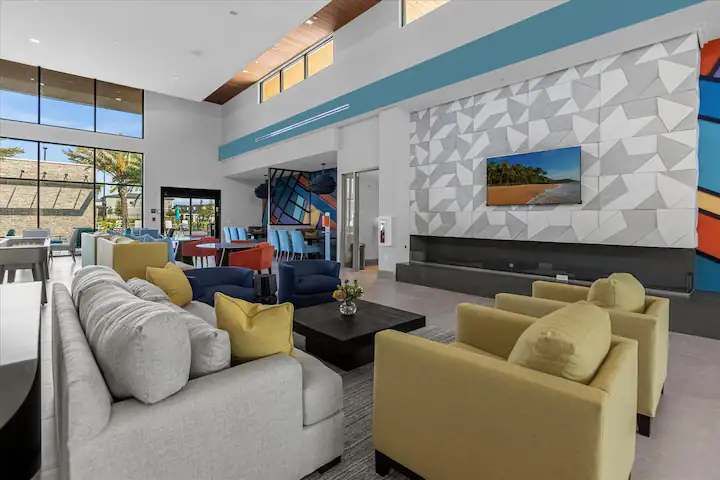 Stylish clubhouse with vibrant décor, cozy seating, and a large flat-screen TV.
Stylish clubhouse with vibrant décor, cozy seating, and a large flat-screen TV.
