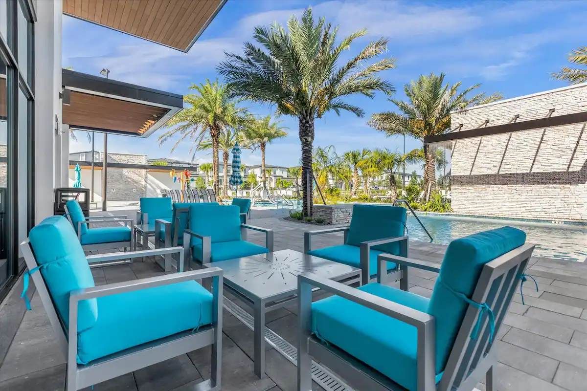 Chic poolside lounge with modern seating, palm views, and resort-style comfort.
