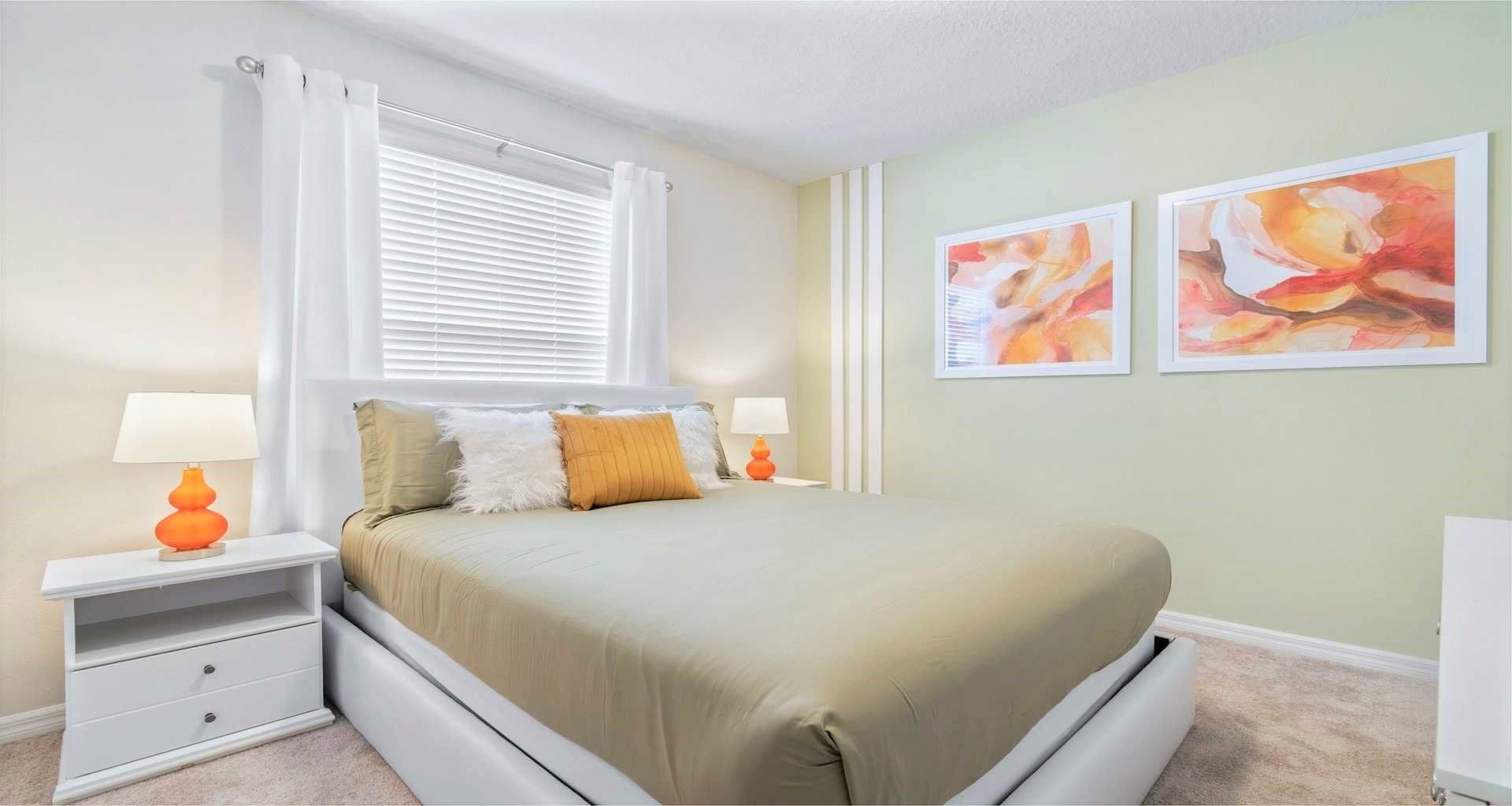 Neat and tidy queen bedroom equipped with a TV, providing a clean and comfortable space for relaxation and restful nights