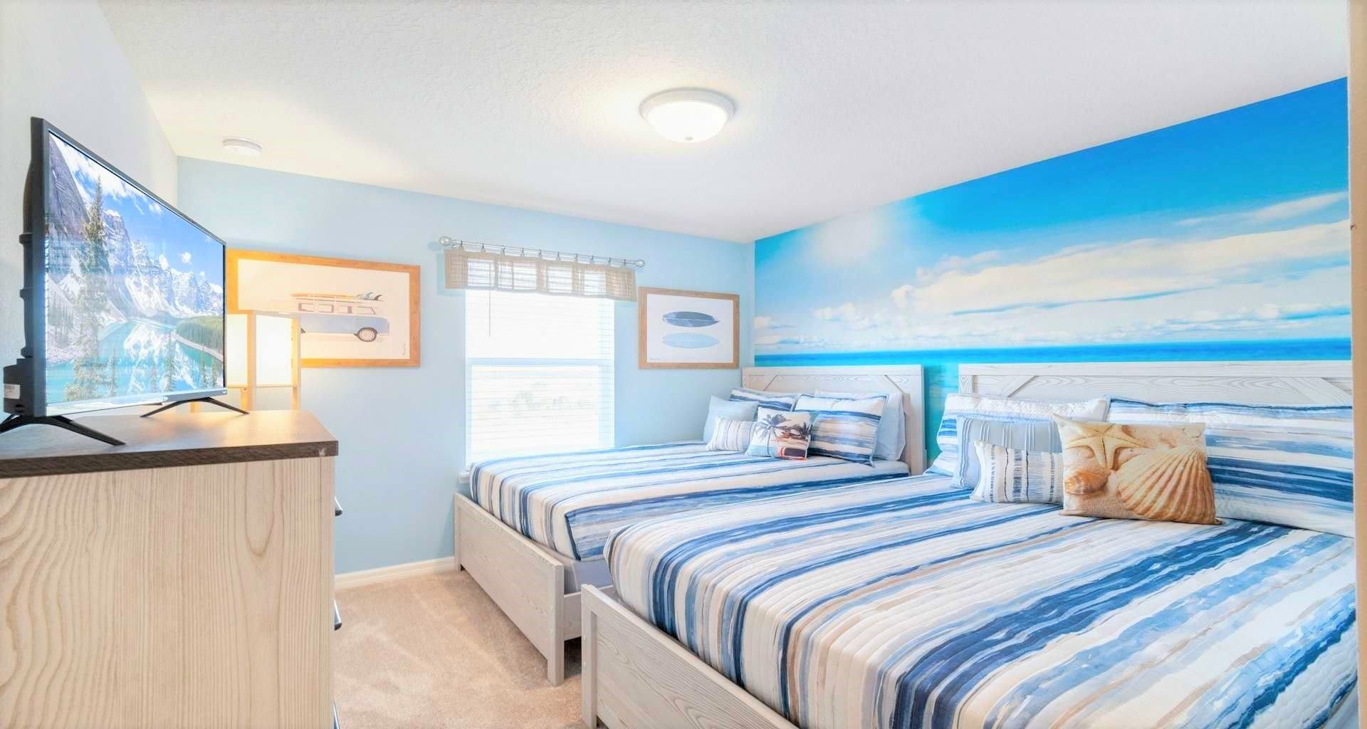 Oceanic-themed bedroom with two full beds, creating a serene and coastal-inspired retreat.