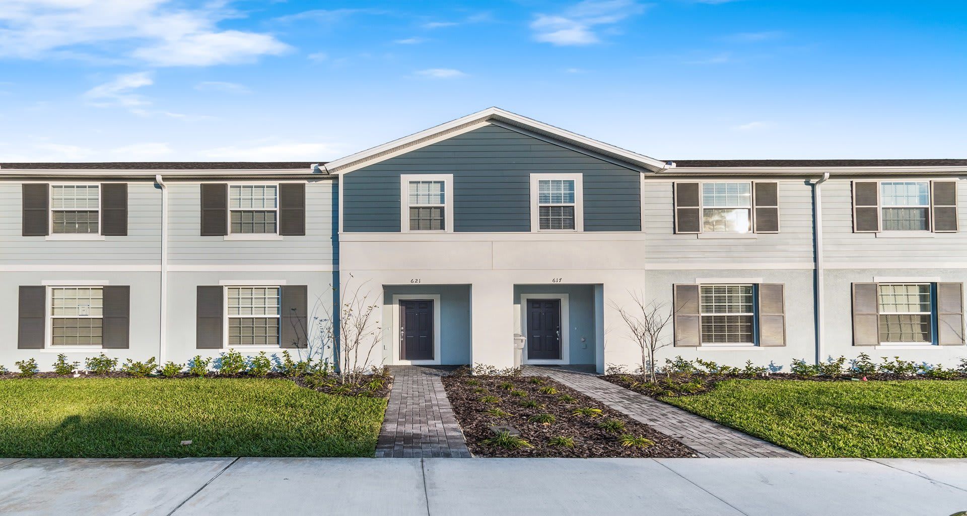 Elegant home surrounded by lush greenery, creating a picturesque and serene environment.