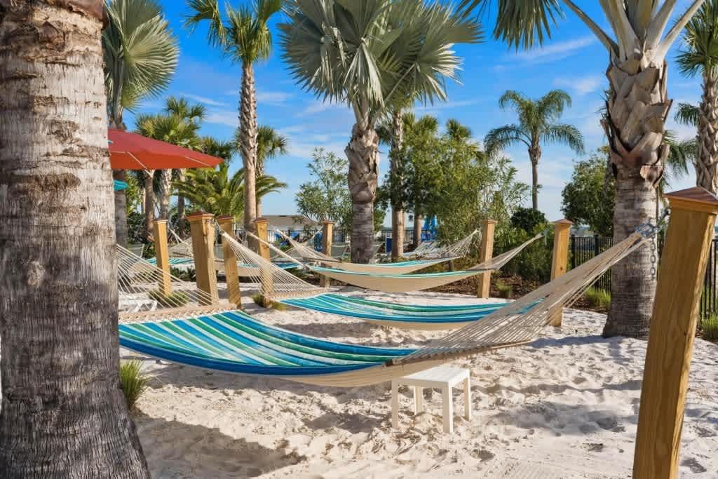 Resort Amenities - Relax in style by the resort lazy pool on comfortable hammock and chairs setup, offering you the perfect spot to unwind and soak up the serene ambiance.