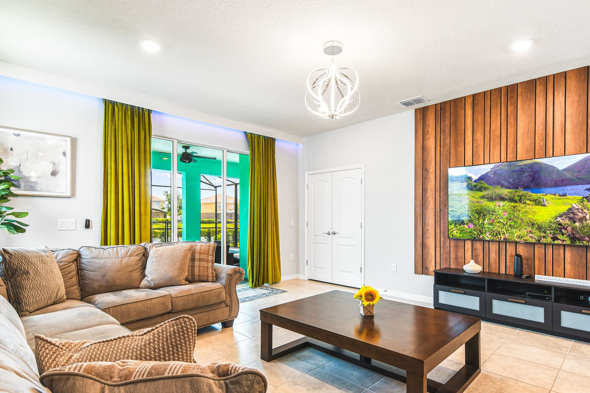 Vibrant living room with modern decor and a stunning nature view, inviting relaxation and enjoyment!