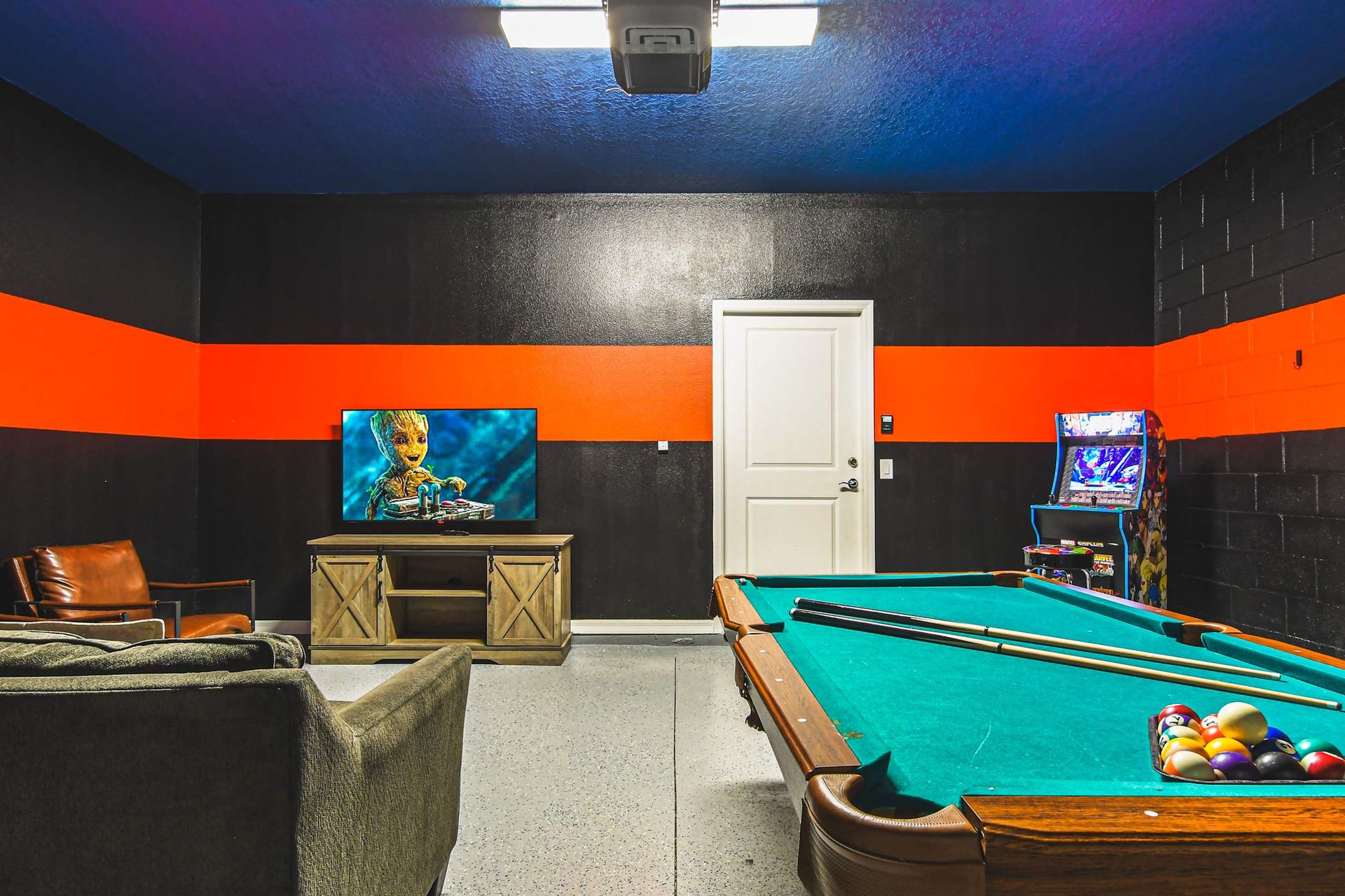 Dive into fun in this electrifying game room, featuring cool arcade games and a sleek pool table for endless entertainment!