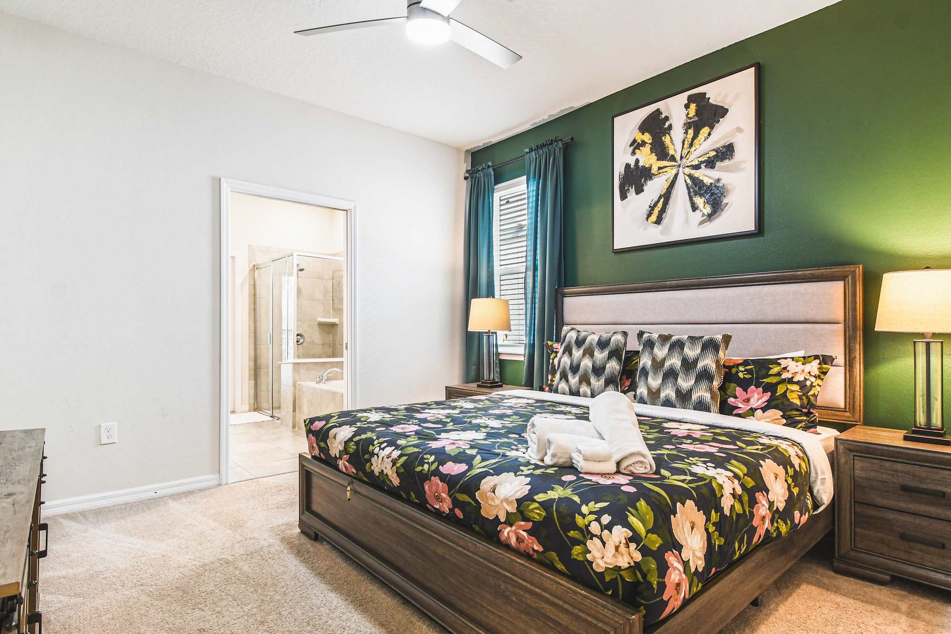 Chic and serene bedroom retreat with lush green walls and vibrant floral accents, perfect for tranquil nights.