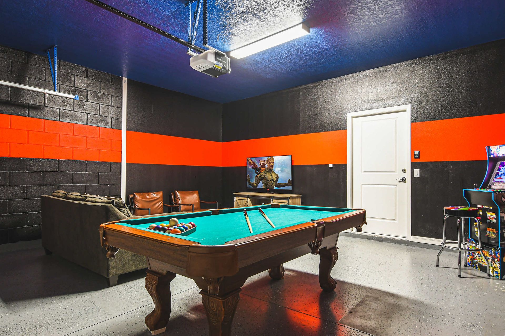Game on! This bold game room is the ultimate hangout with its vibrant colors, pool table, and arcade fun!