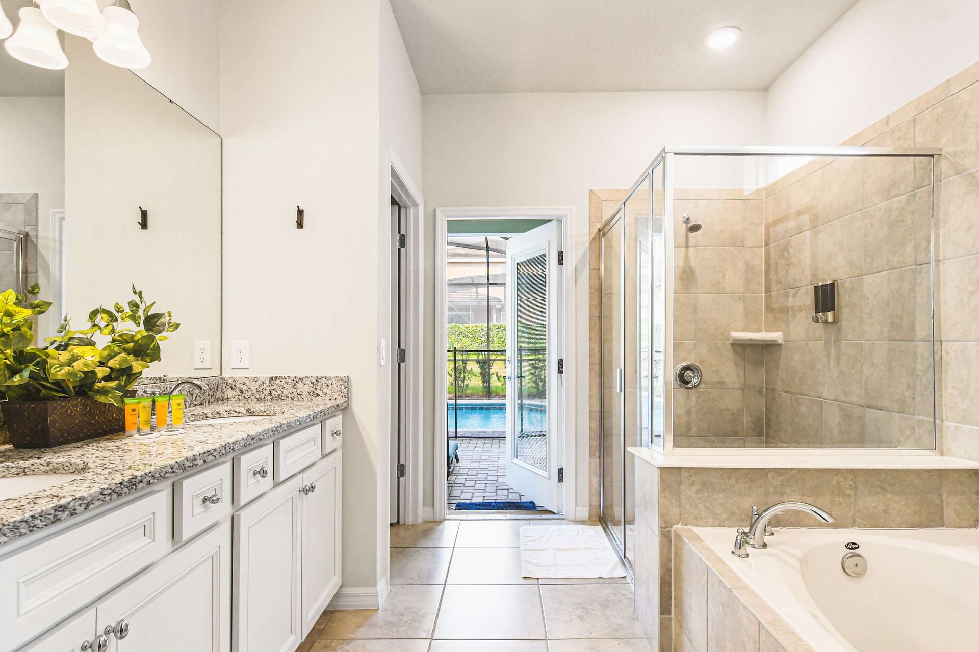 Indulge in this luxurious bathroom with a spa-like feel, direct pool access, and elegant finishes—true relaxation awaits!