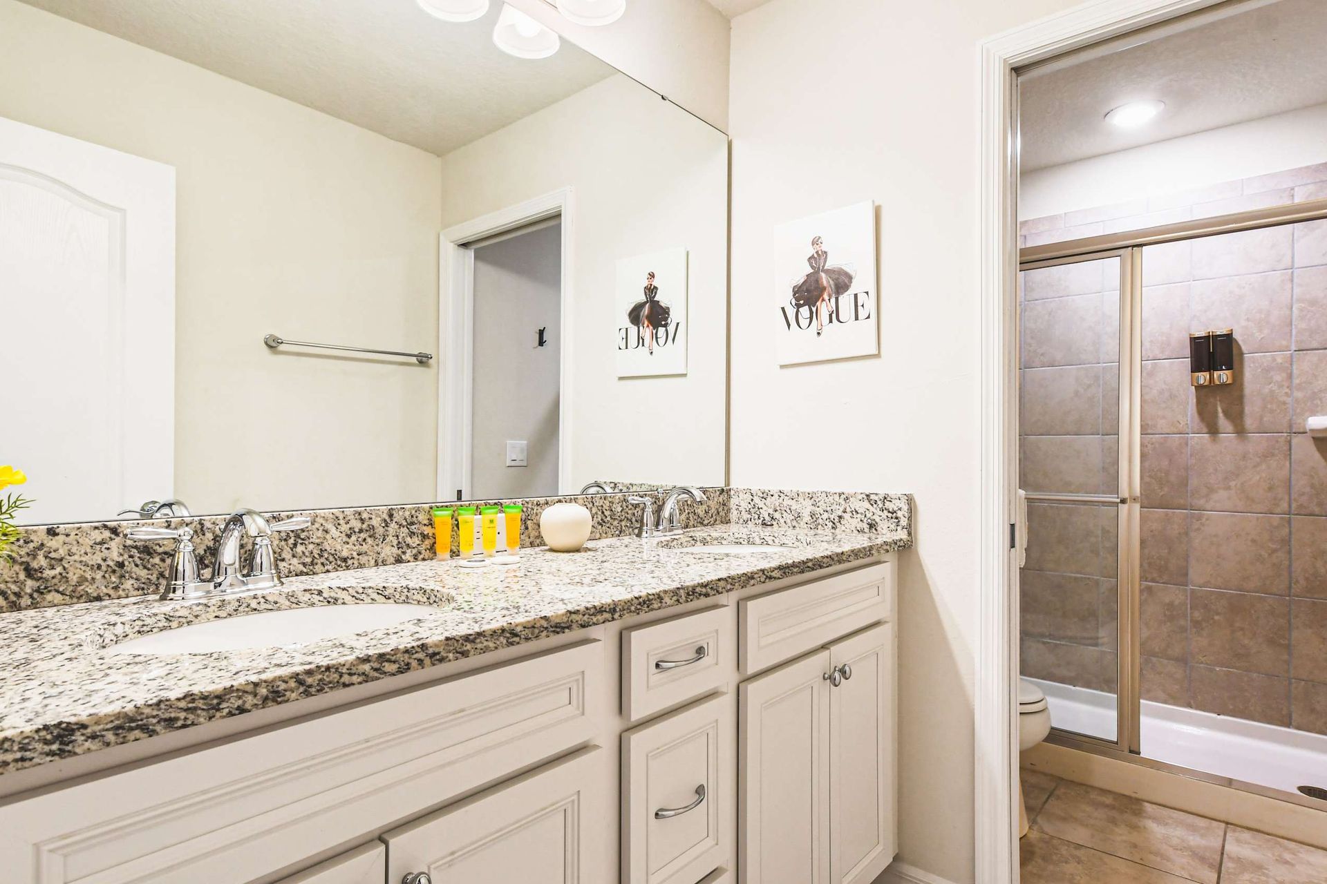 Chic bathroom with stylish accents and spacious vanity, offering a touch of luxury and perfect lighting for pampering!