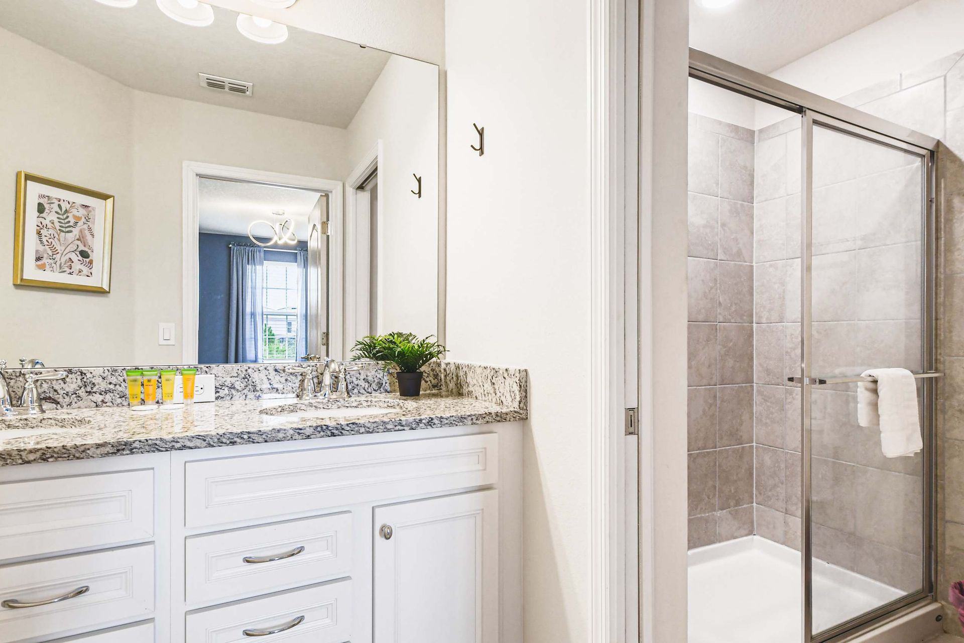 Bright and clean bathroom with elegant granite countertops and a serene view, perfect for refreshing mornings.