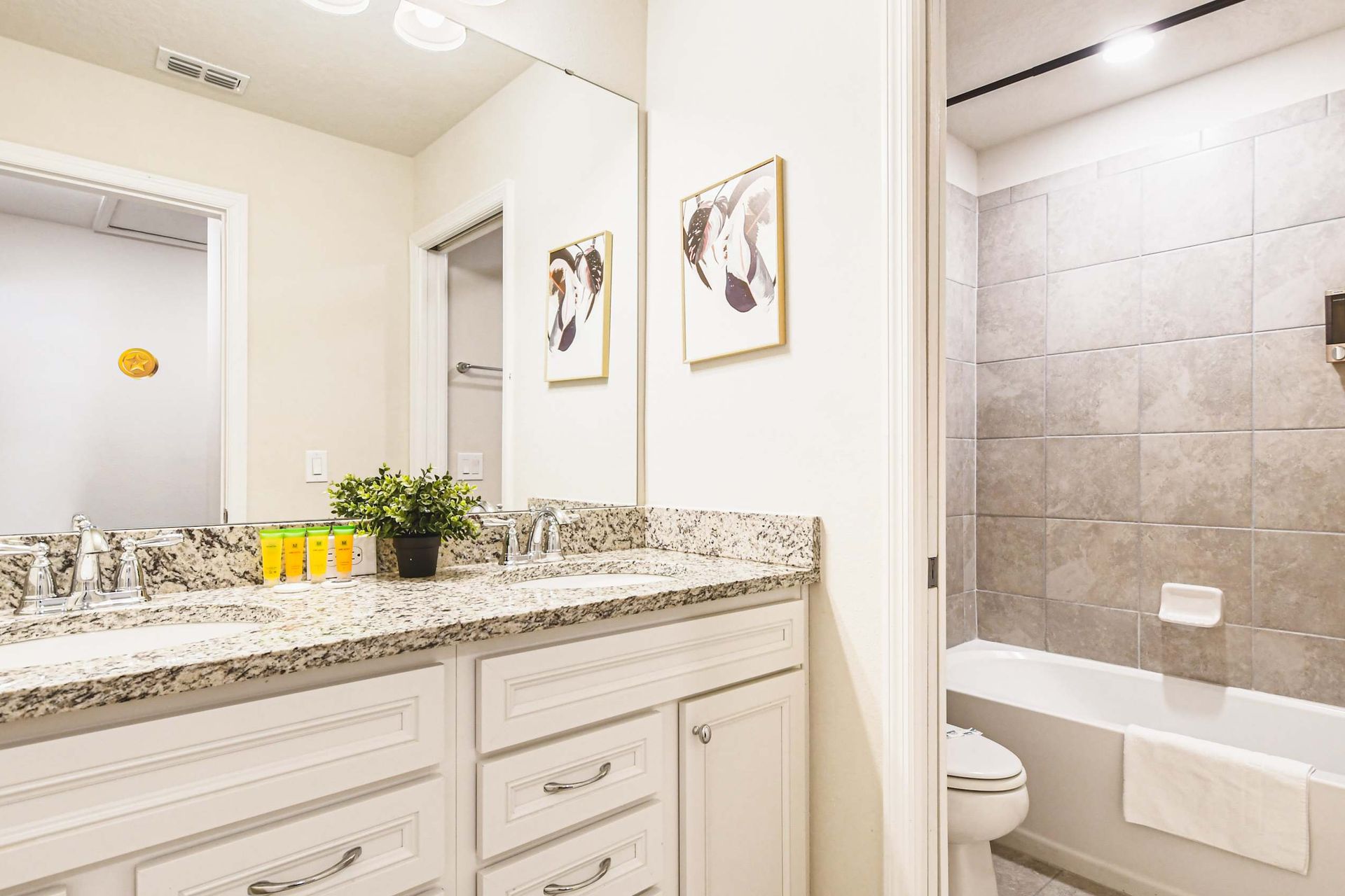 Chic bathroom with stylish accents and spacious vanity, offering a touch of luxury and perfect lighting for pampering!