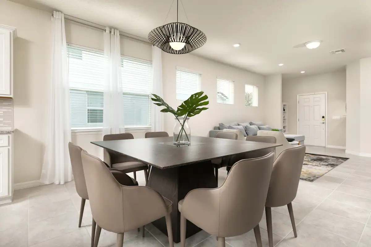 Modern dining space with elegant seating, natural light, and a stylish centerpiece.