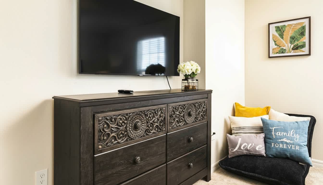 Elegant carved wood dresser and cozy reading nook create a serene, luxury bedroom retreat.