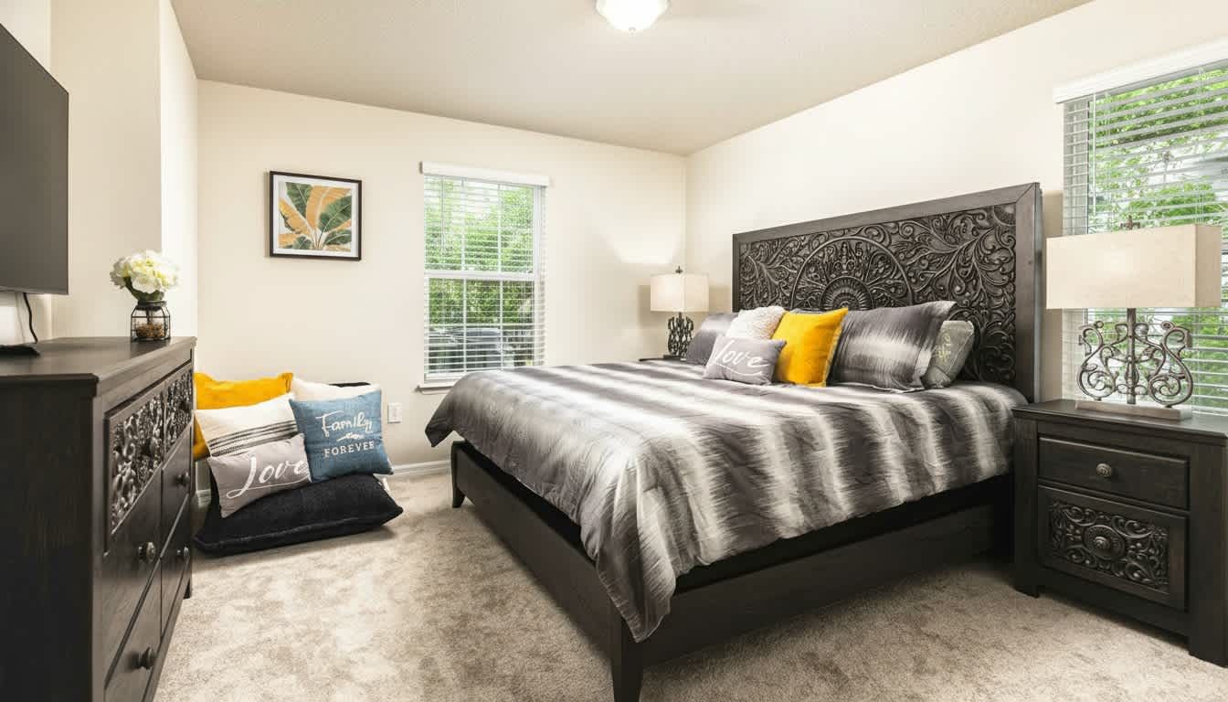 Serene retreat featuring an intricately carved statement headboard and plush, designer accents.