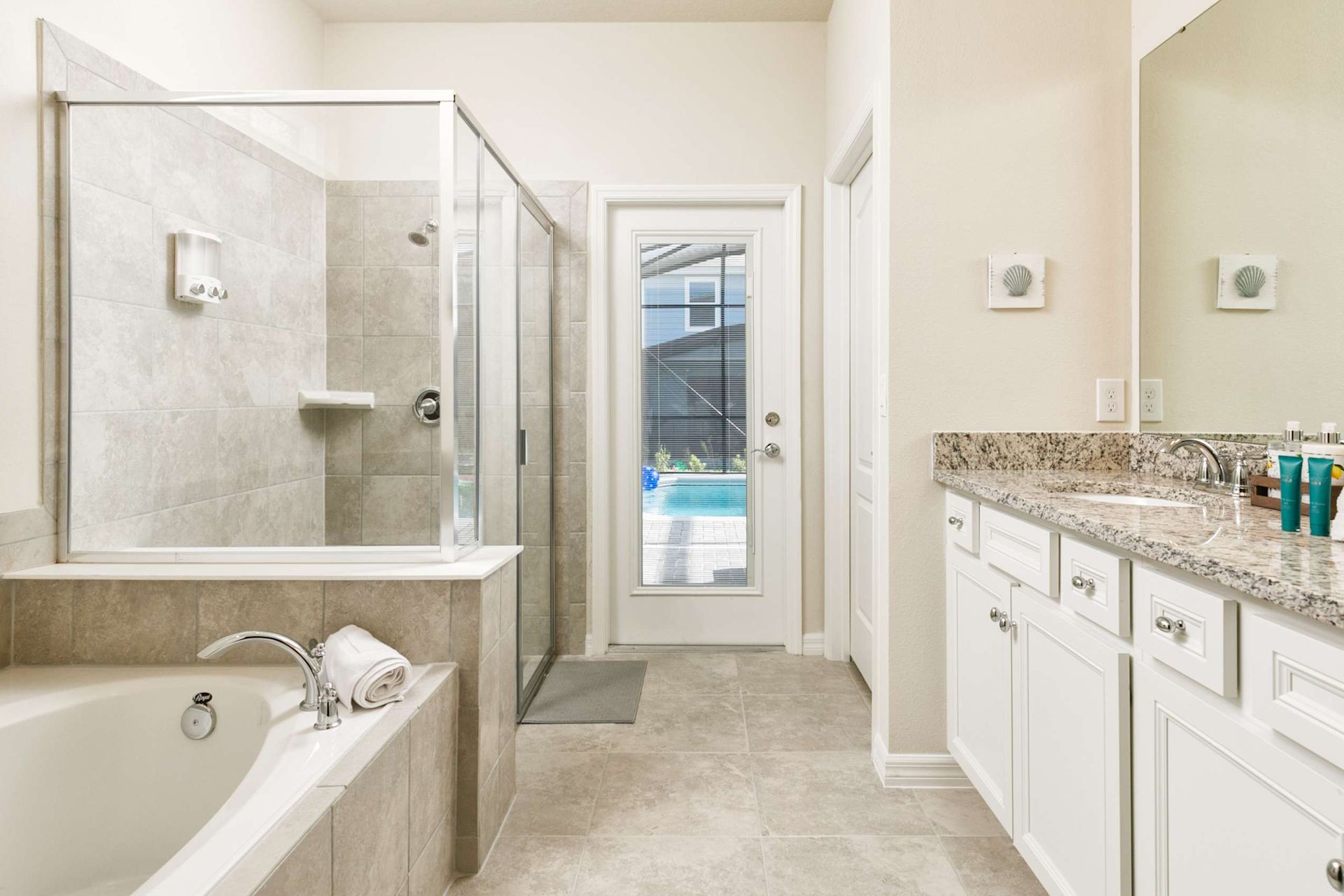 Indulge in a spa-like retreat featuring a deep soaking tub and seamless outdoor pool access.