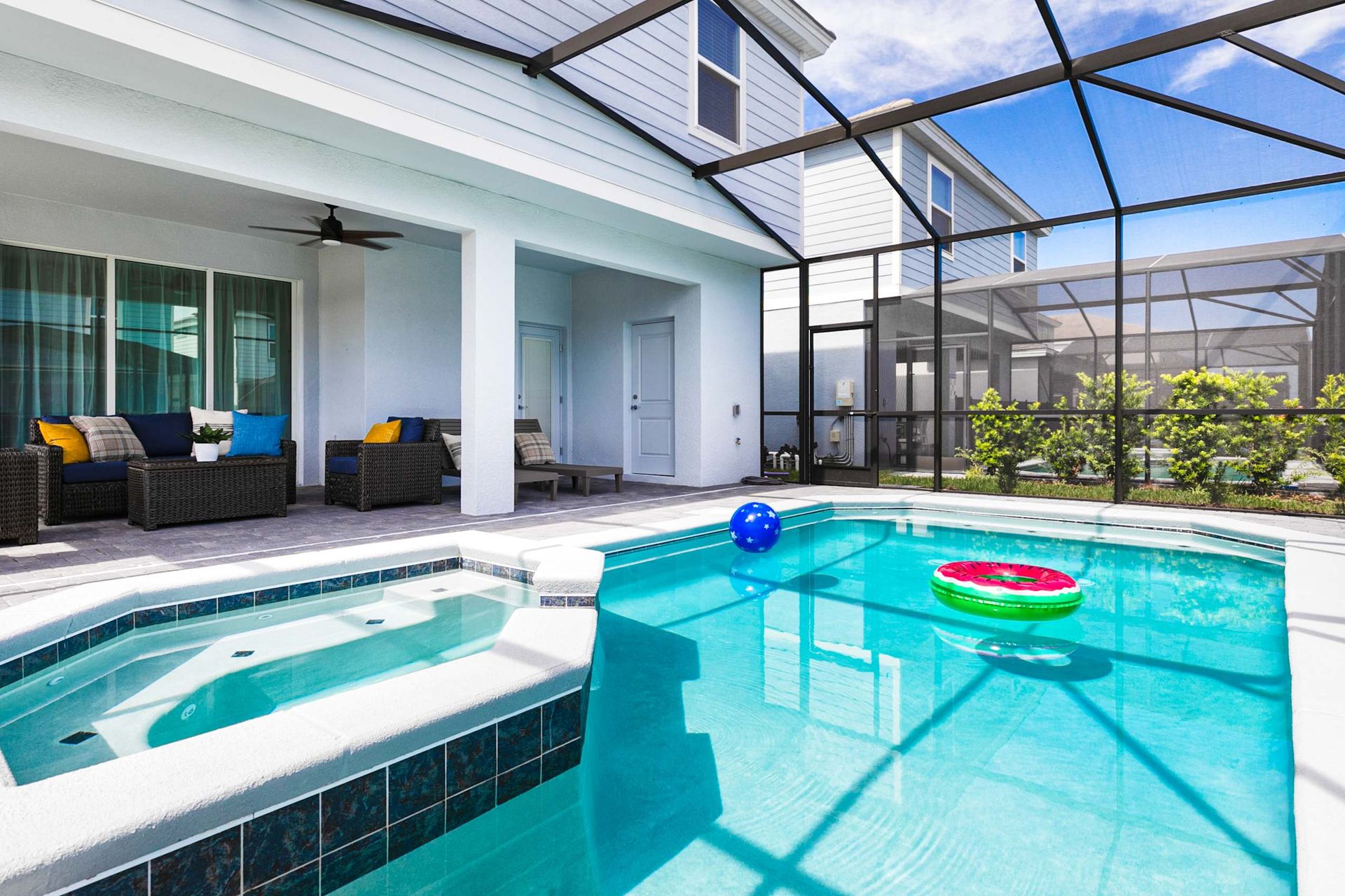 Dive into serenity with this sun-drenched private pool and spa oasis under the Florida sky.