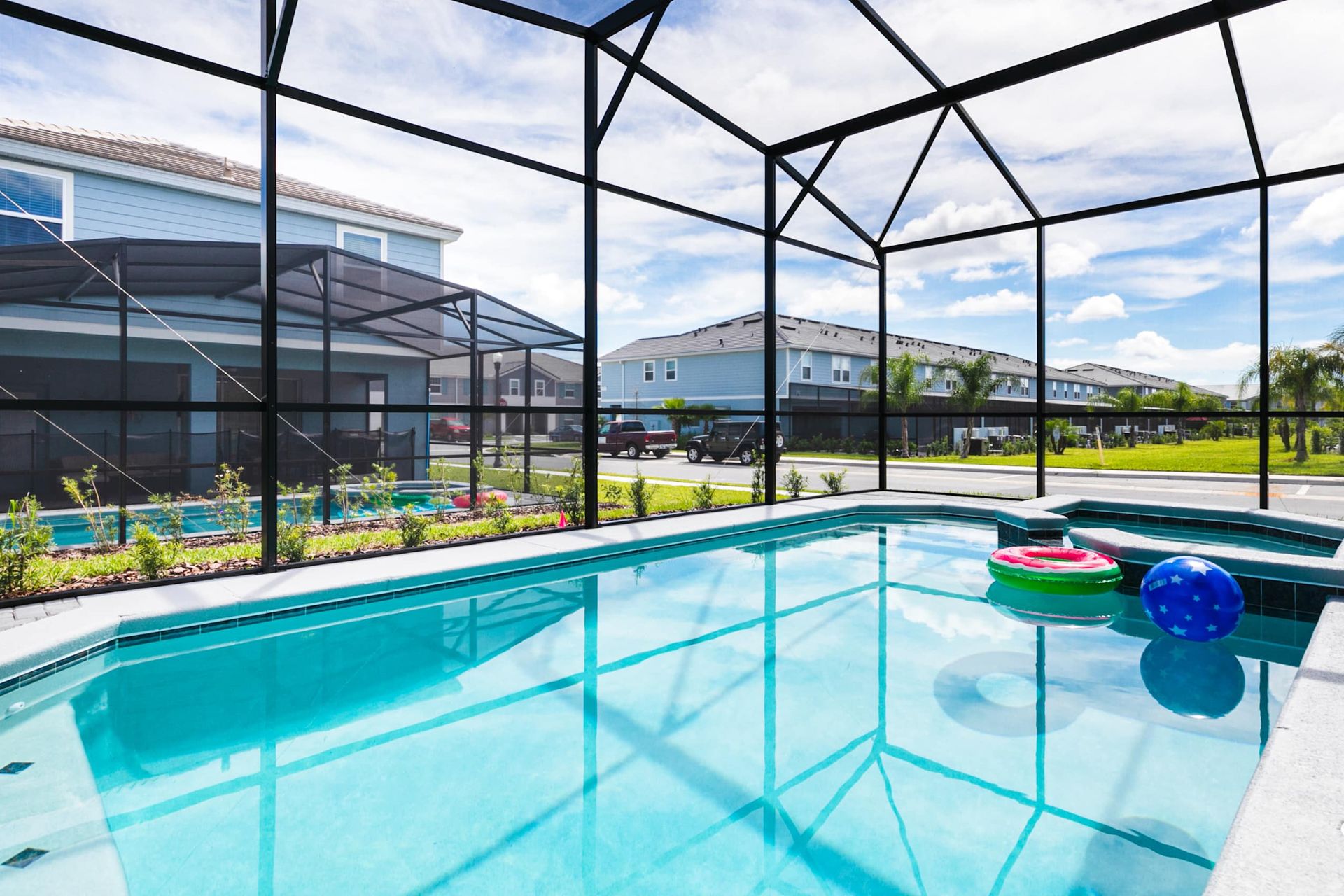 Immaculate private pool retreat featuring crystal clear waters under a soaring screen enclosure.