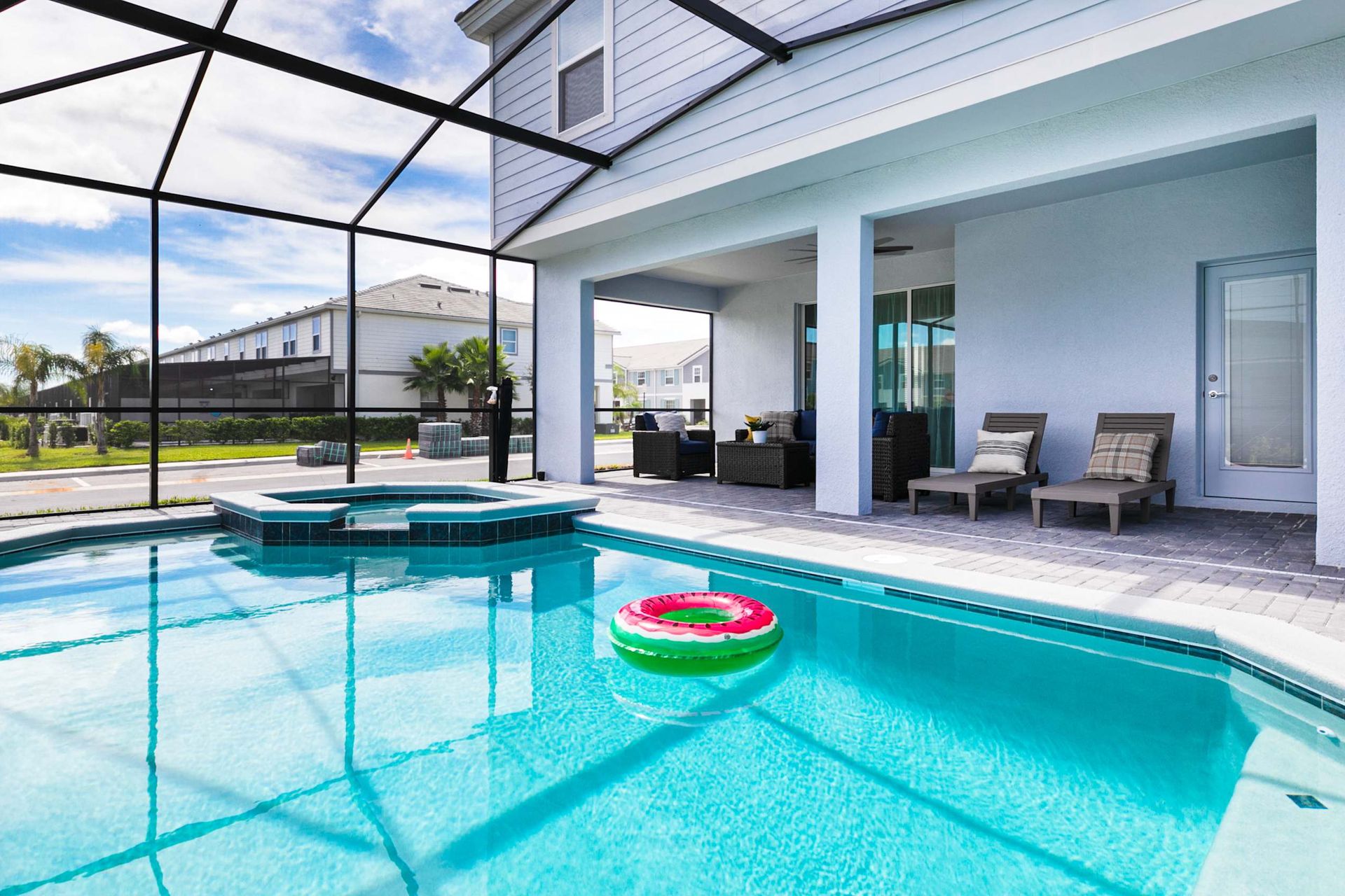 Sun-drenched private oasis with a sparkling pool and integrated spa under a screened lanai.