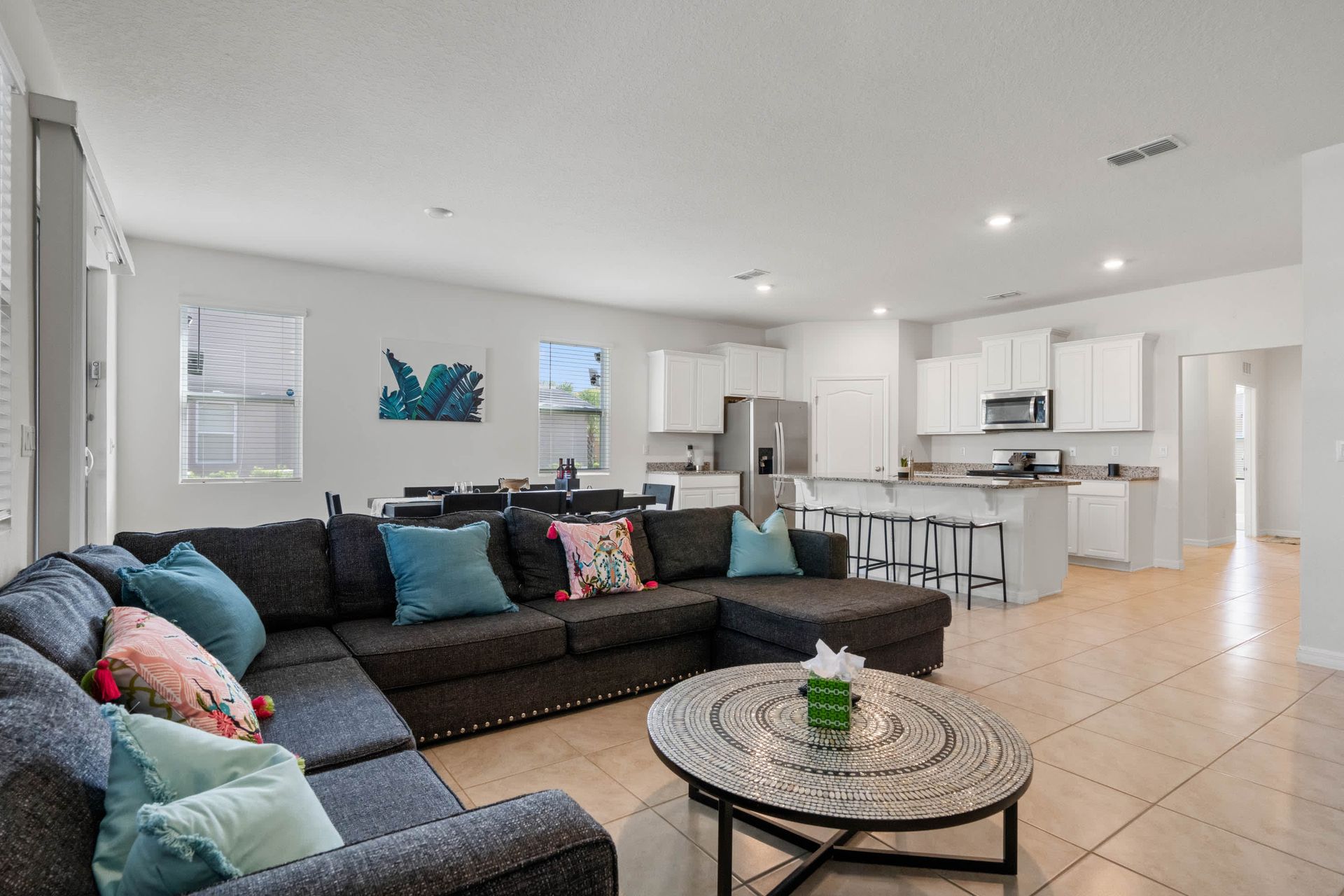 Spacious open-plan living with comfy sectional, modern kitchen, and dining for eight.