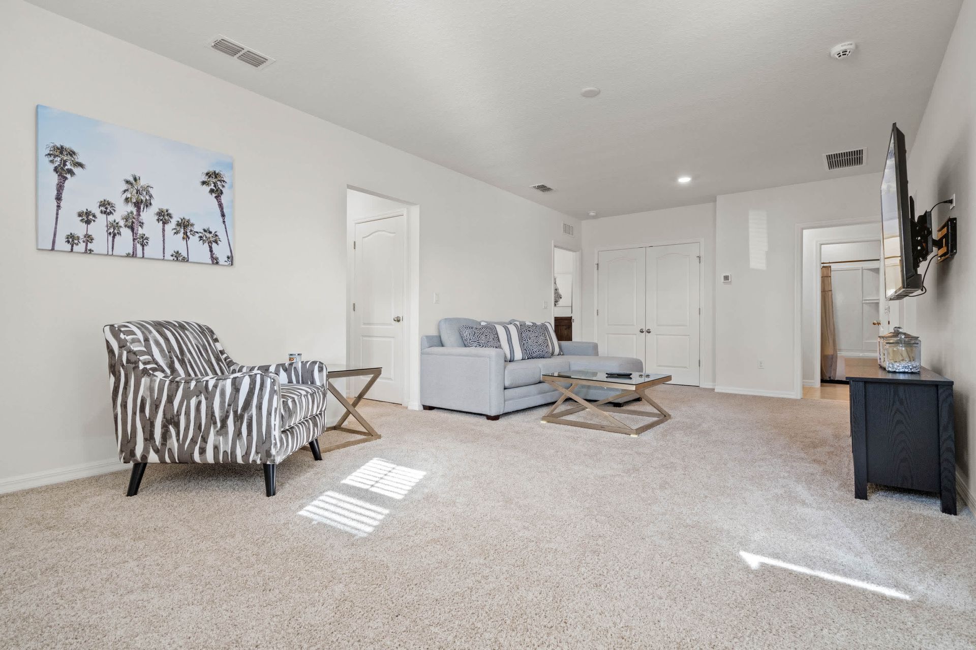 Upstairs loft with cozy seating, smart TV, and plush carpet for relaxing nights.