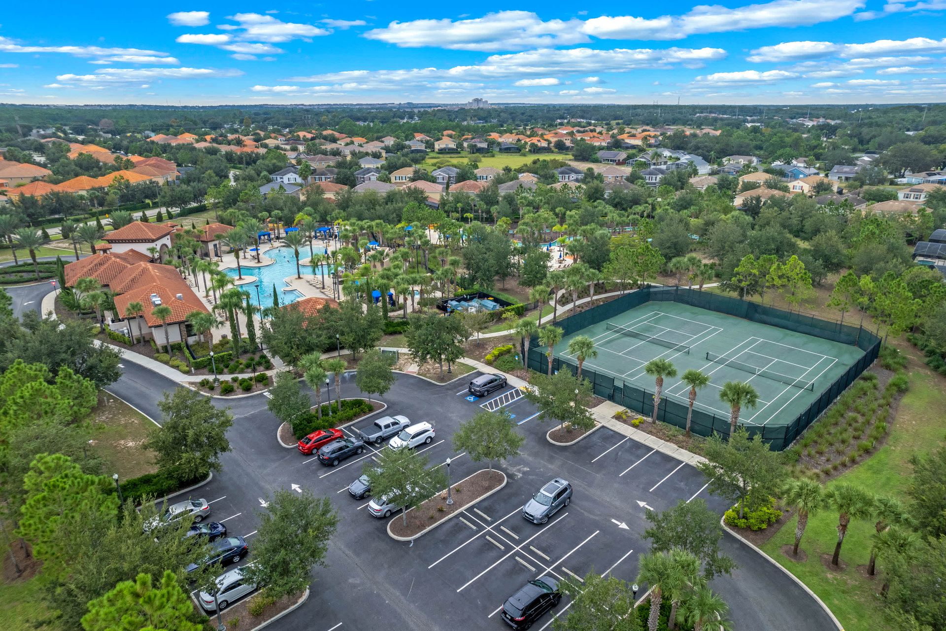 Luxury resort amenities: lagoon pool, splash park, tennis courts, and clubhouse
