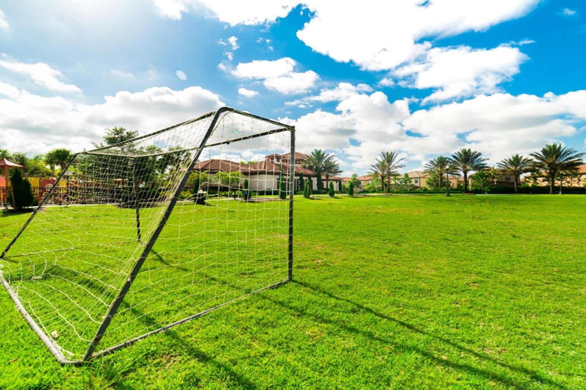 Open green field with soccer goals, perfect for games, play, and family fun
