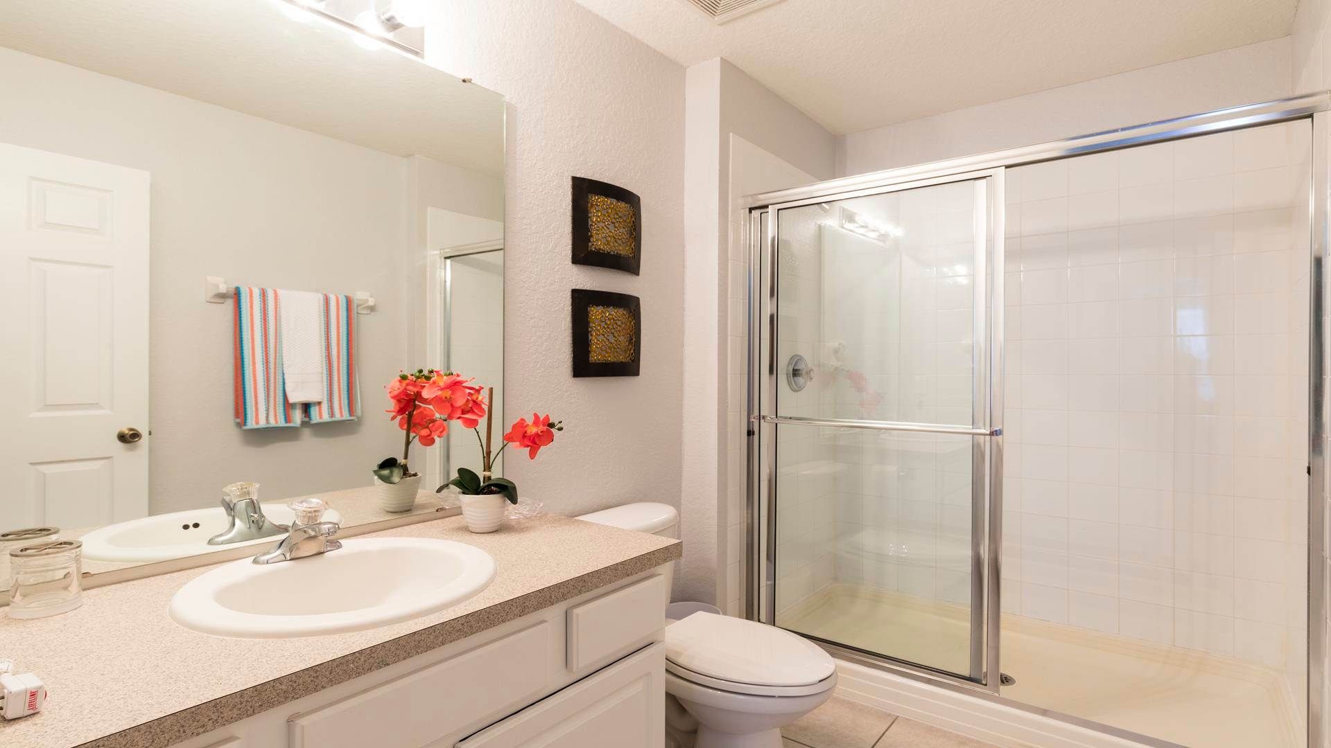 Bright and stylish bathroom with a spacious walk-in shower and modern decor.
