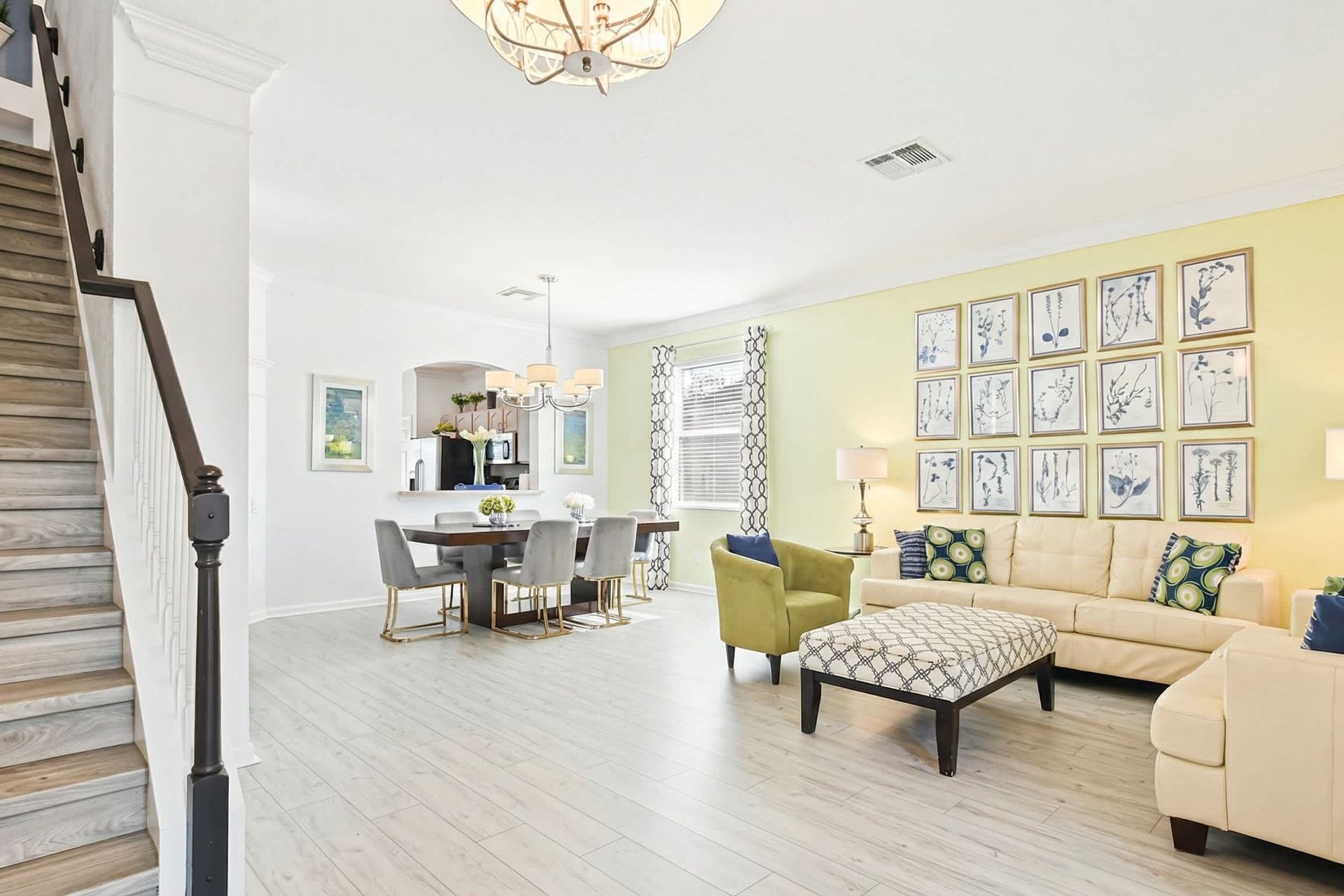 Stylish open living space with dining, modern kitchen views, and bright accents.