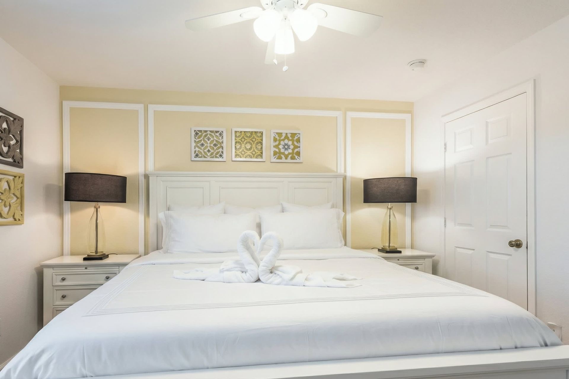 Stylish king room with cozy bedding, soft lighting, and warm decorative touches.