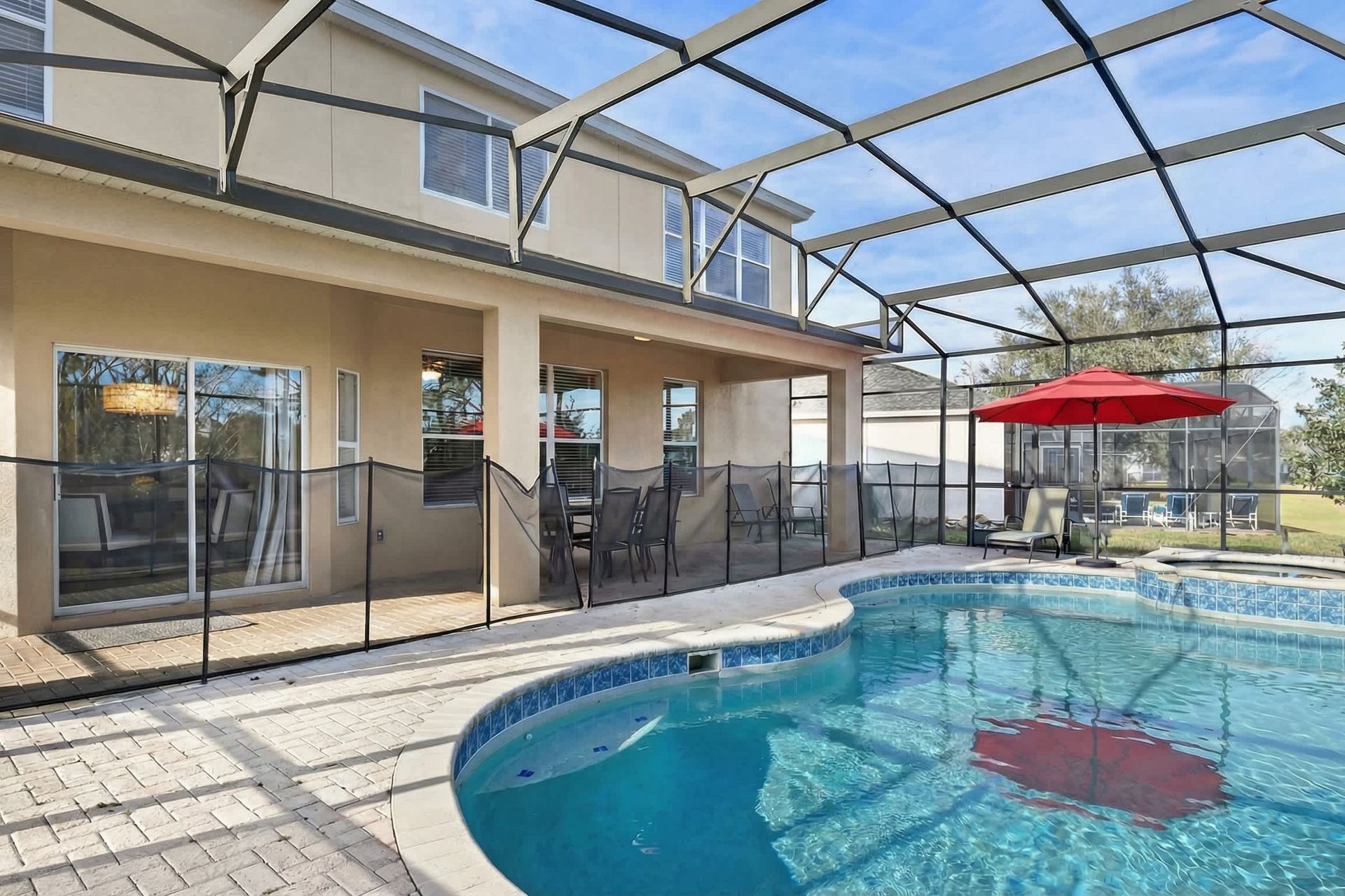 Spacious screened pool with spa and plenty of seating for outdoor relaxation.