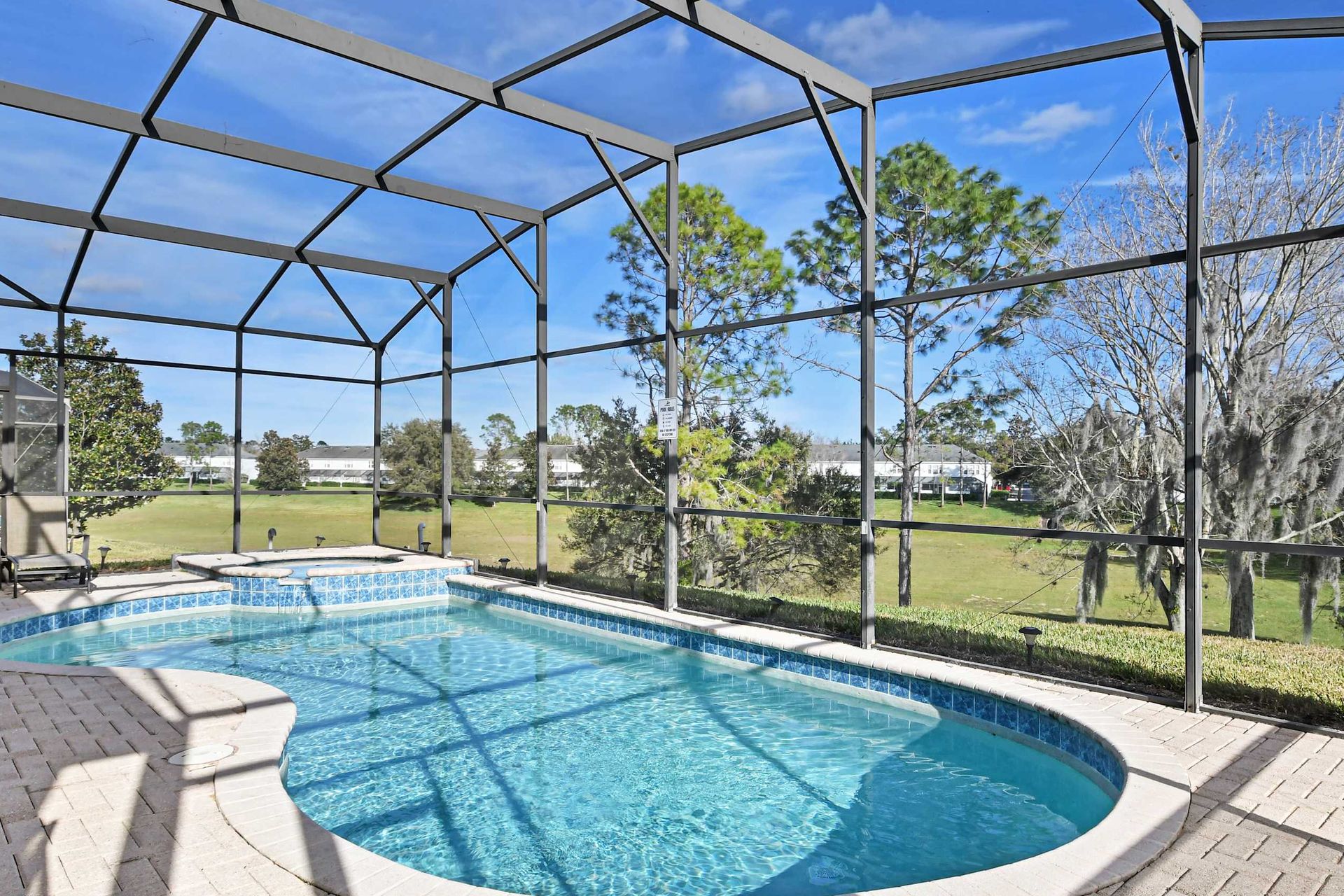 The outdoor green view pool area is a luxurious retreat for relaxation and entertainment. It features a large, heated swimming pool.