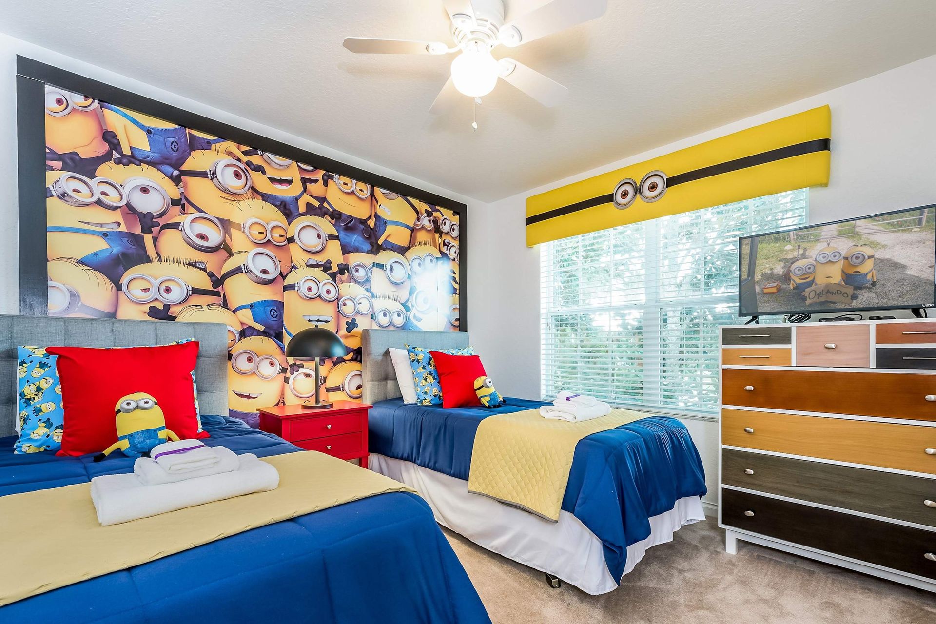 Fun Minions-themed twin room with bright decor, TV, and playful energy.