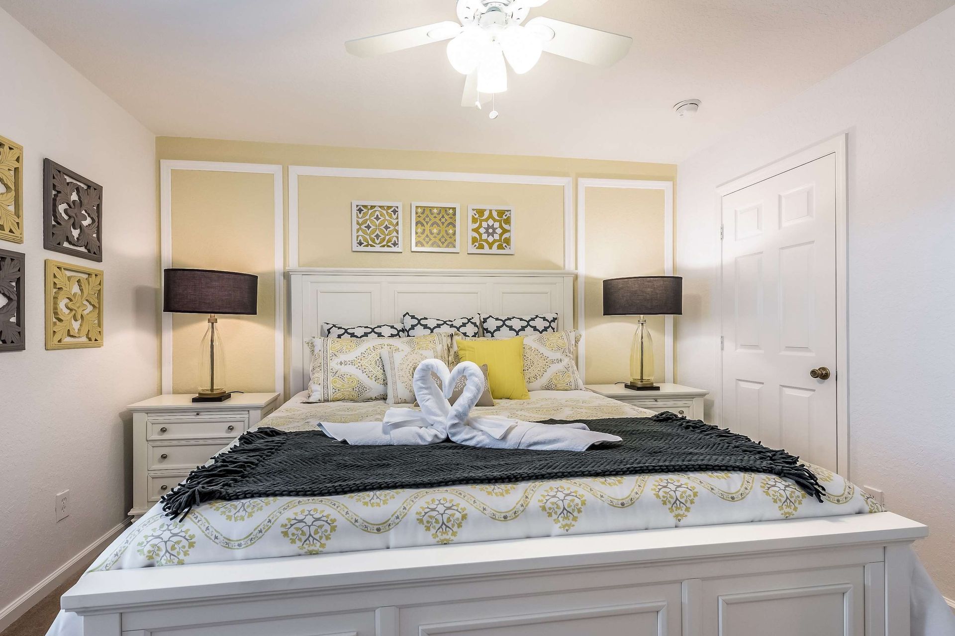 Stylish king room with cozy bedding, soft lighting, and warm decorative touches.