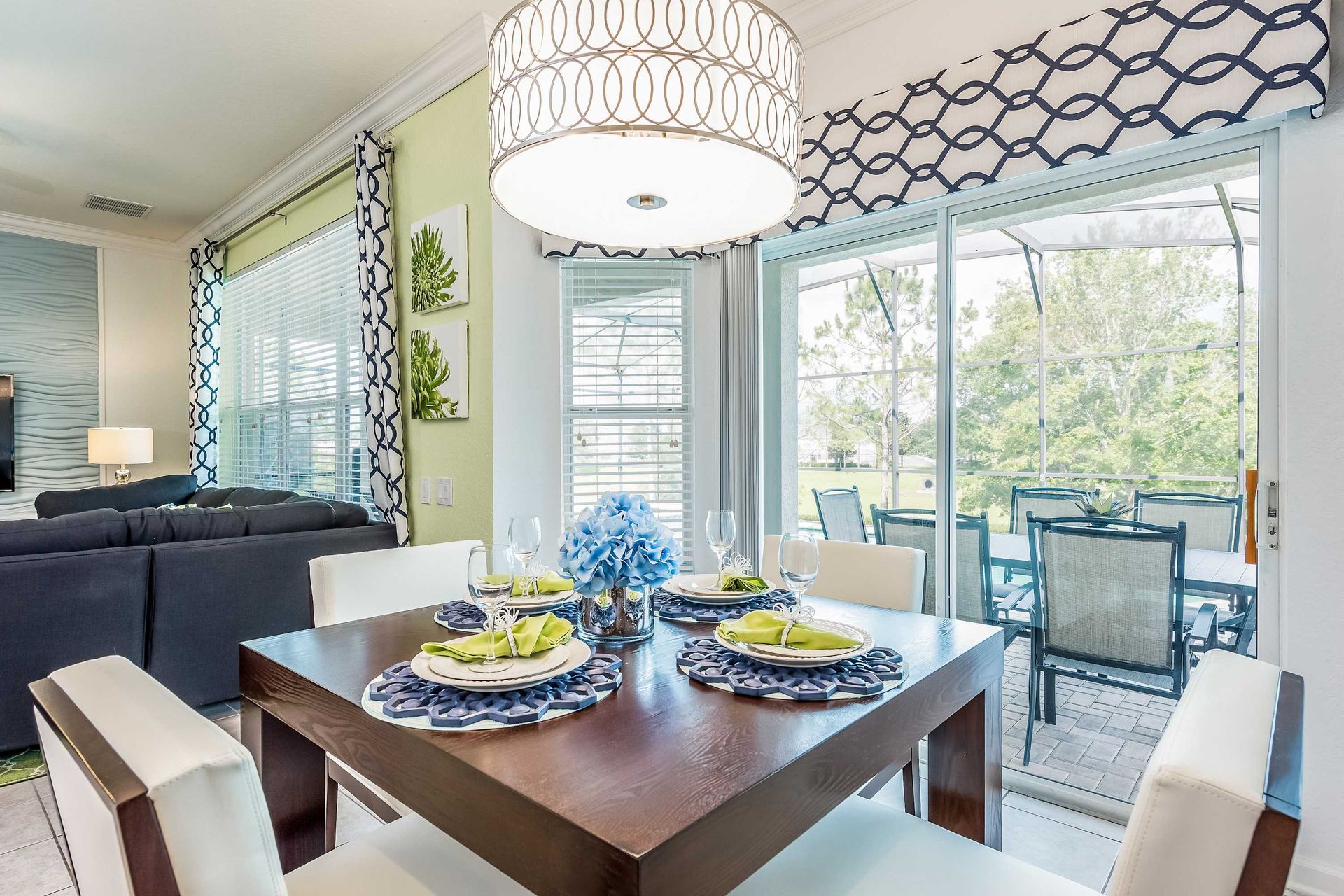 Cozy breakfast nook with pool views, stylish decor, and natural sunlight.