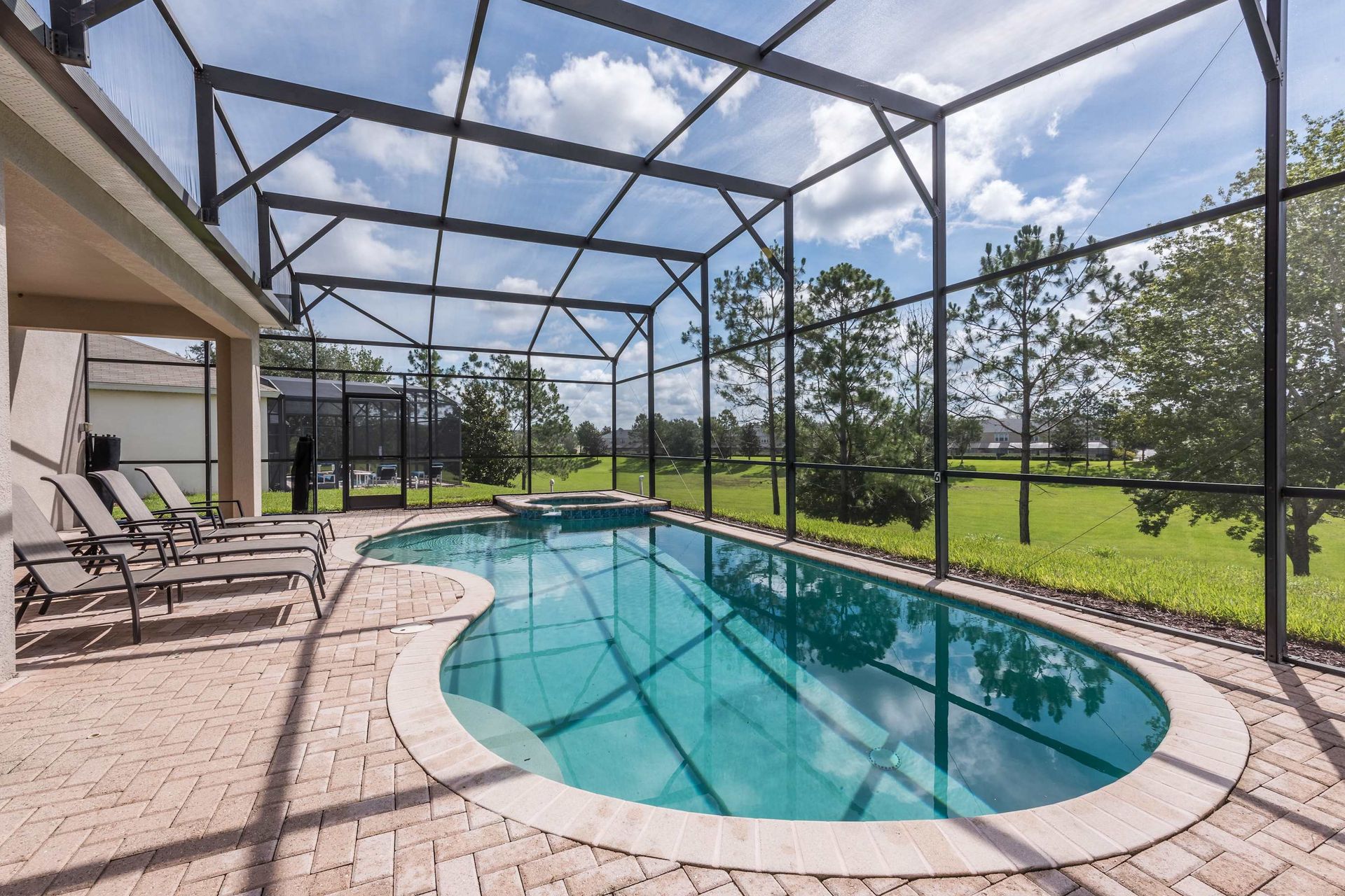 Relax in the screened private pool and spa with tranquil views of the greenbelt.