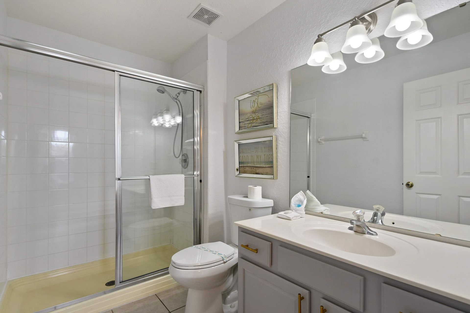 Clean and bright bathroom with a spacious walk-in shower and modern coastal décor.