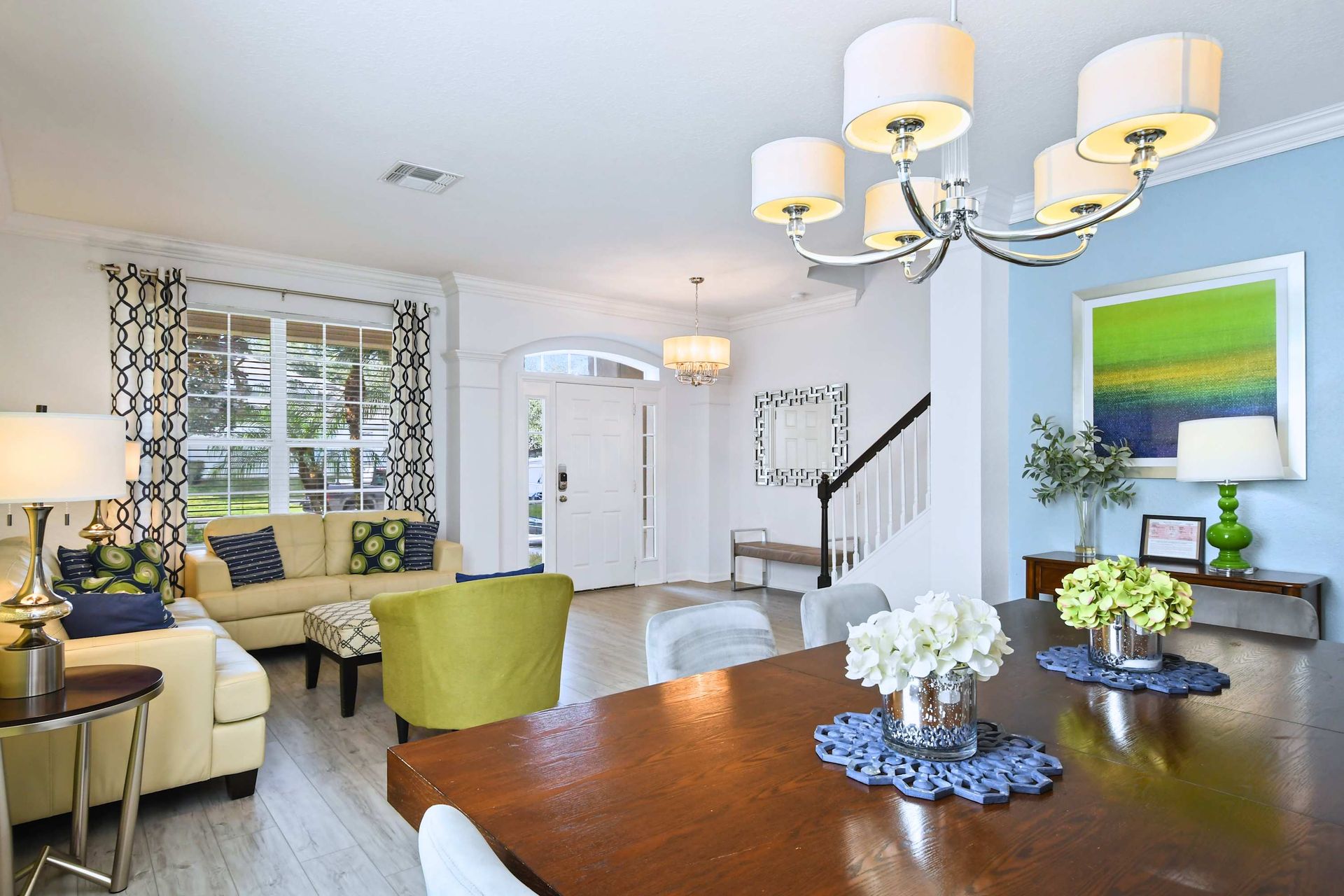Inviting open layout with elegant dining, bright living space, and chic entryway.