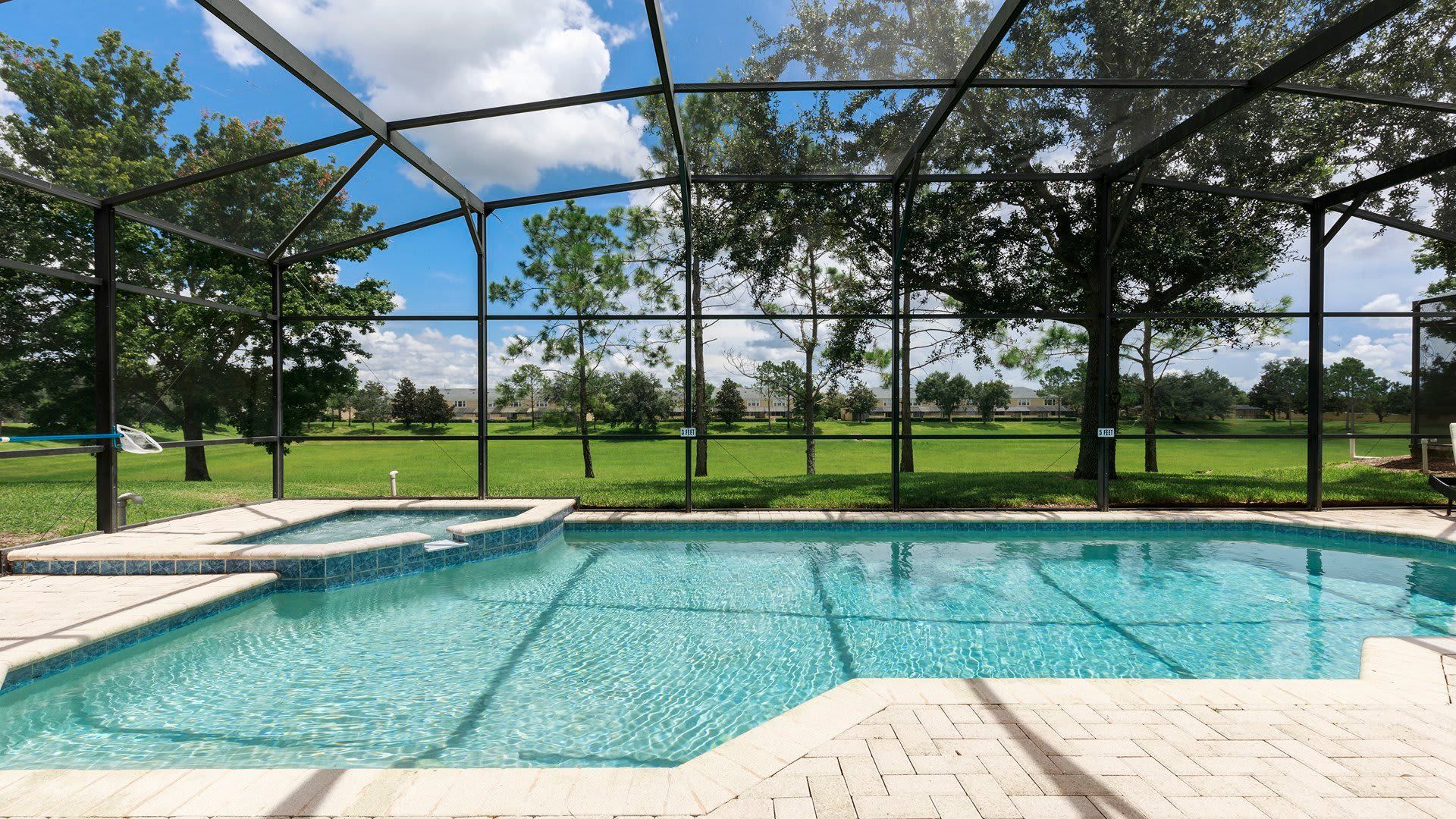 Relax in a private screened-in pool with a spa and stunning nature view
