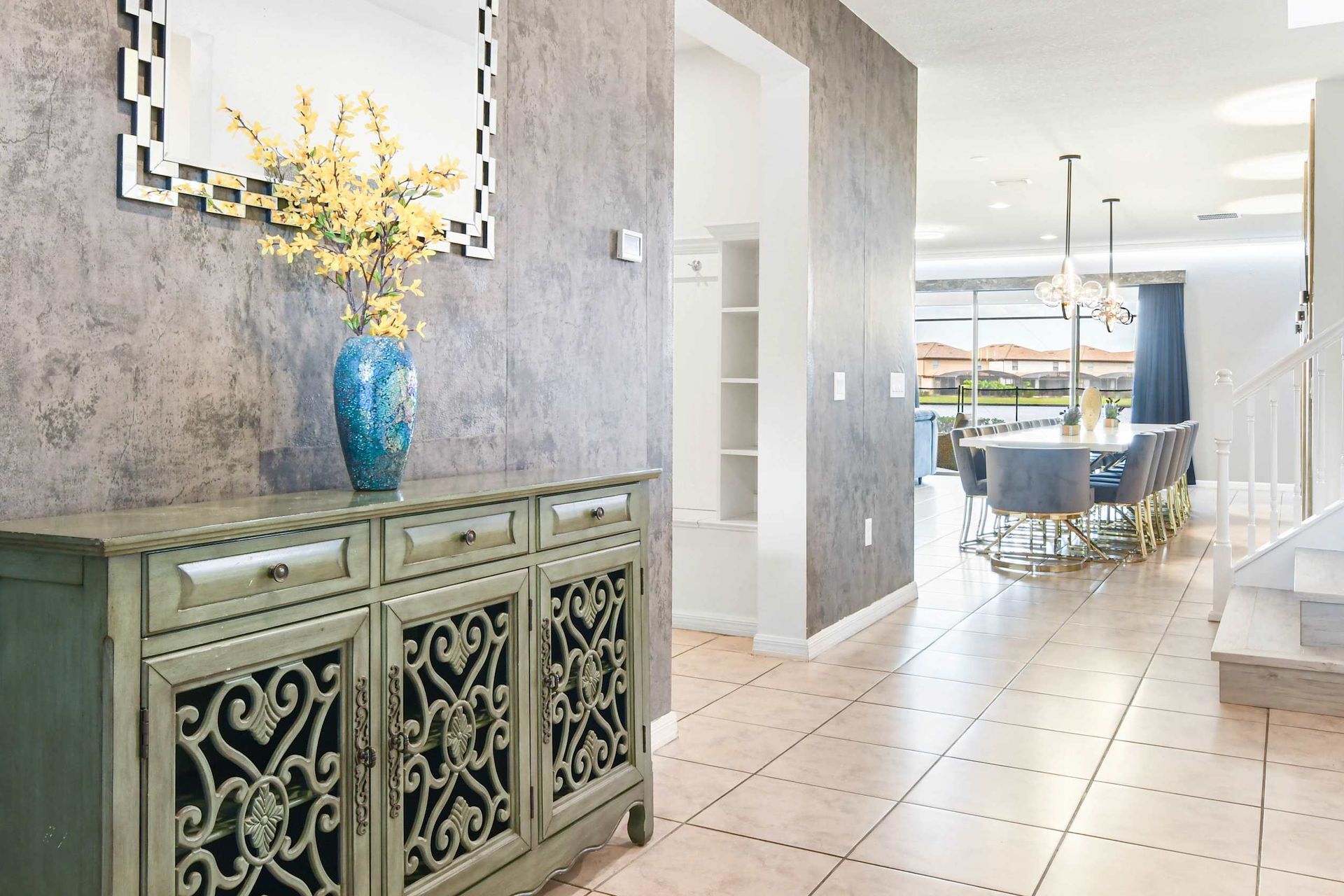 Stylish hallway decor leading to a bright, elegant dining area.