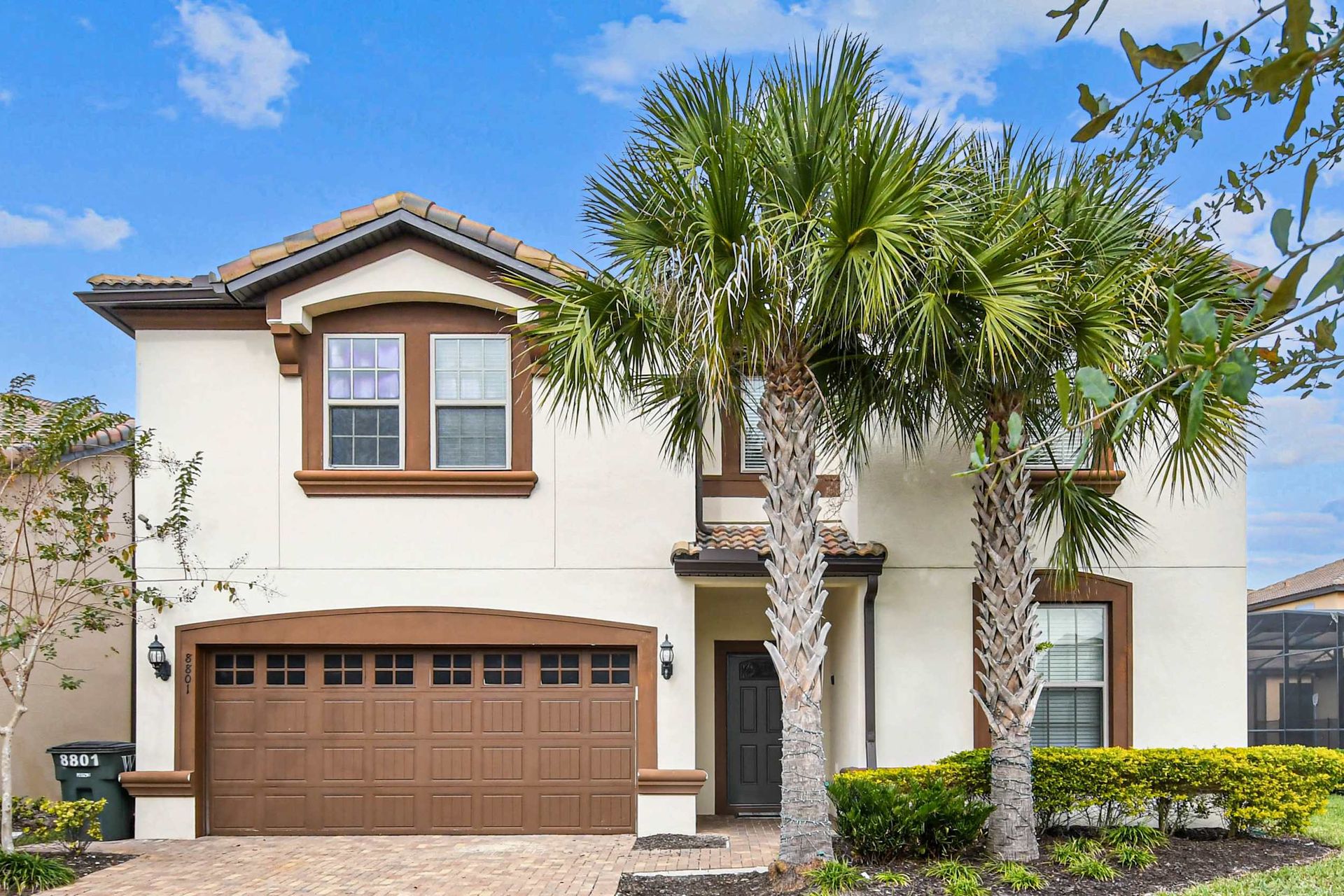 Charming villa with lush palms, spacious garage, and cozy vibe!