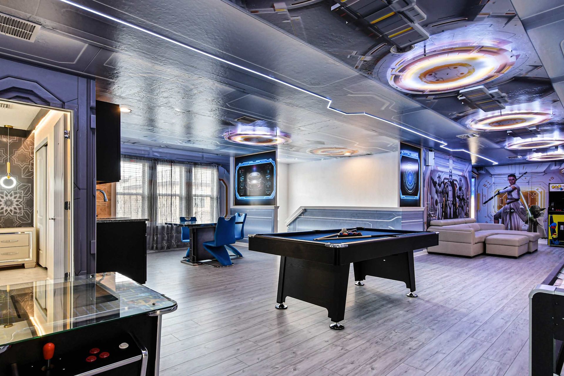 Futuristic game room with pool, arcade, and lounge area!