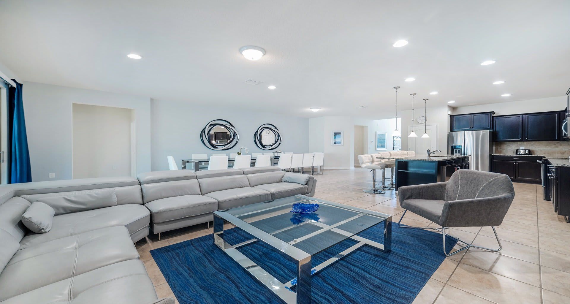 Open-concept living, dining, and kitchen area with modern style and ample space.