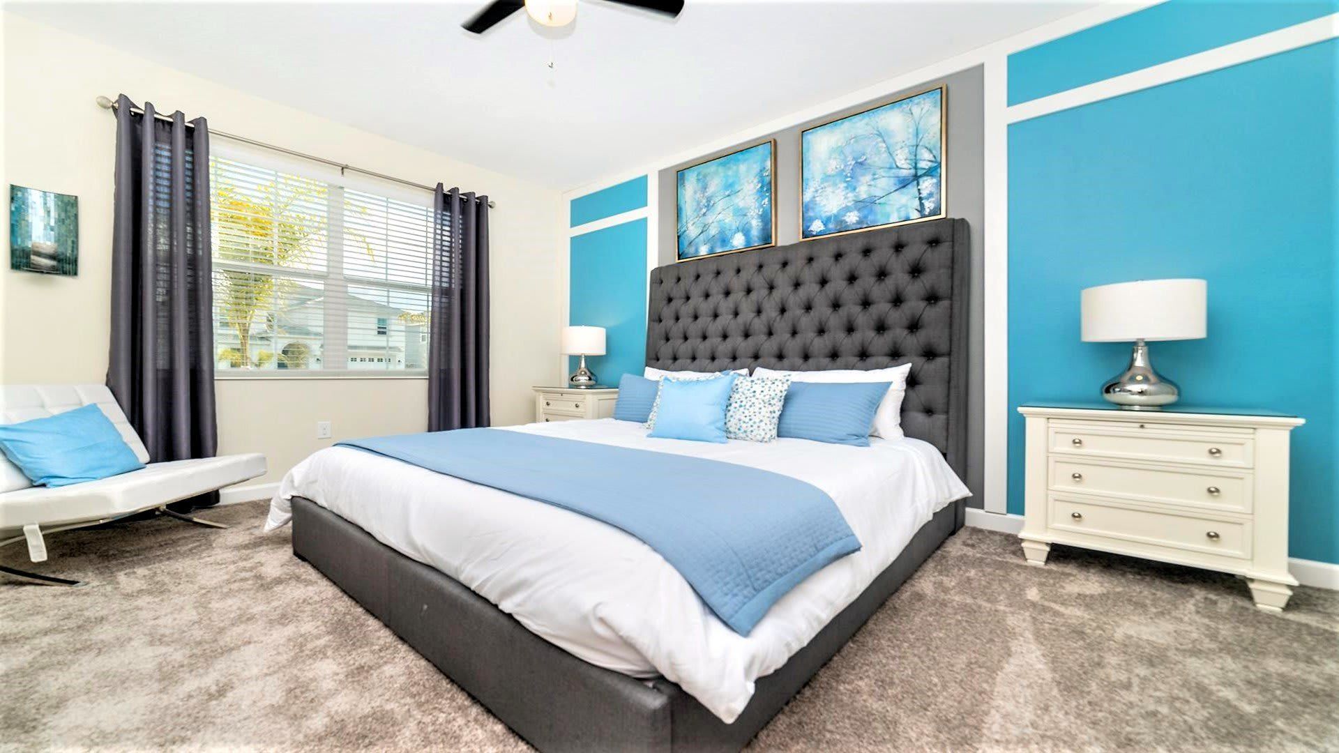Bright bedroom with modern decor, plush bedding, and calming blue accents.