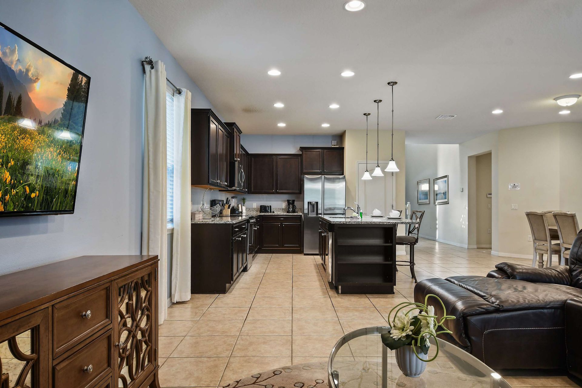Open-concept living with a modern kitchen, comfy seating, and stylish decor.