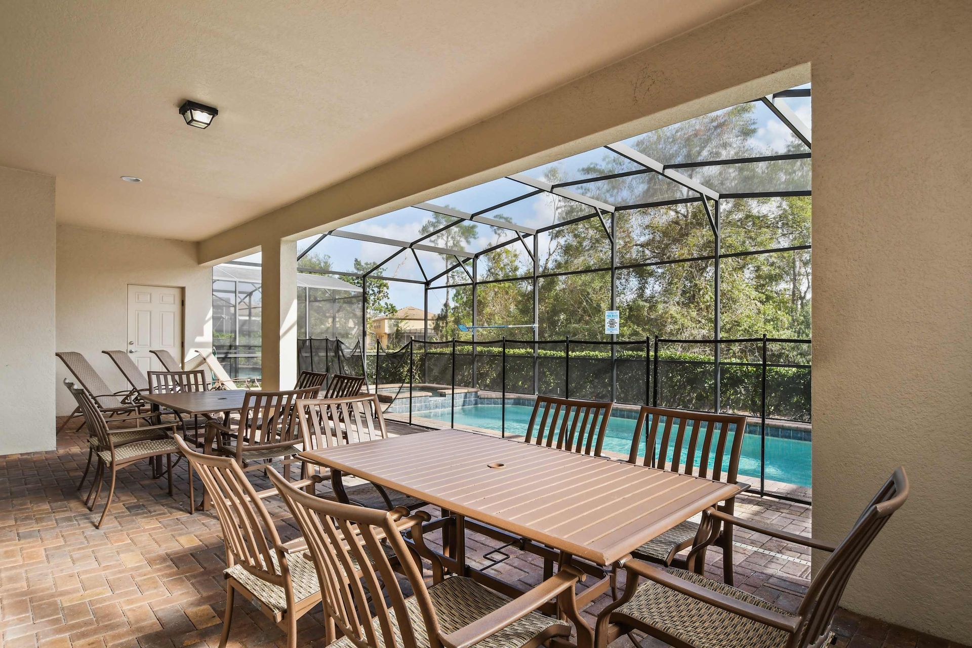 Shaded patio with plenty of seating, views of the pool, and room for outdoor dining.