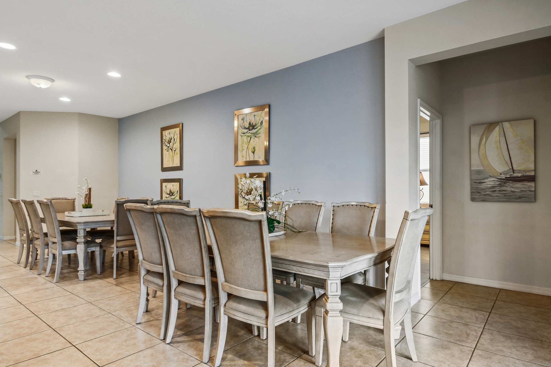 Elegant dining area with seating for eight, pool views, and tasteful decor.