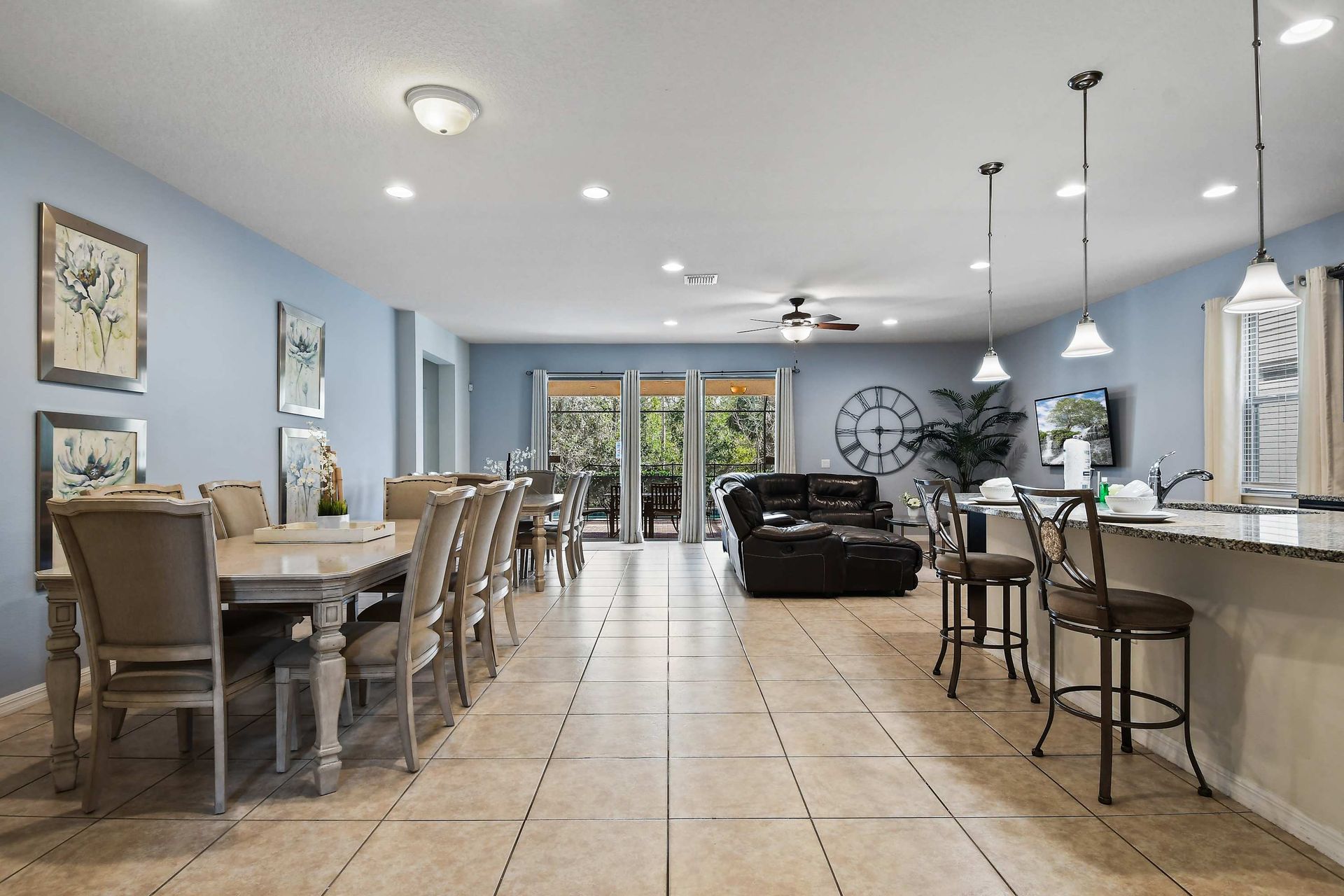 Spacious open-concept home with modern decor, pool view, and ample seating.