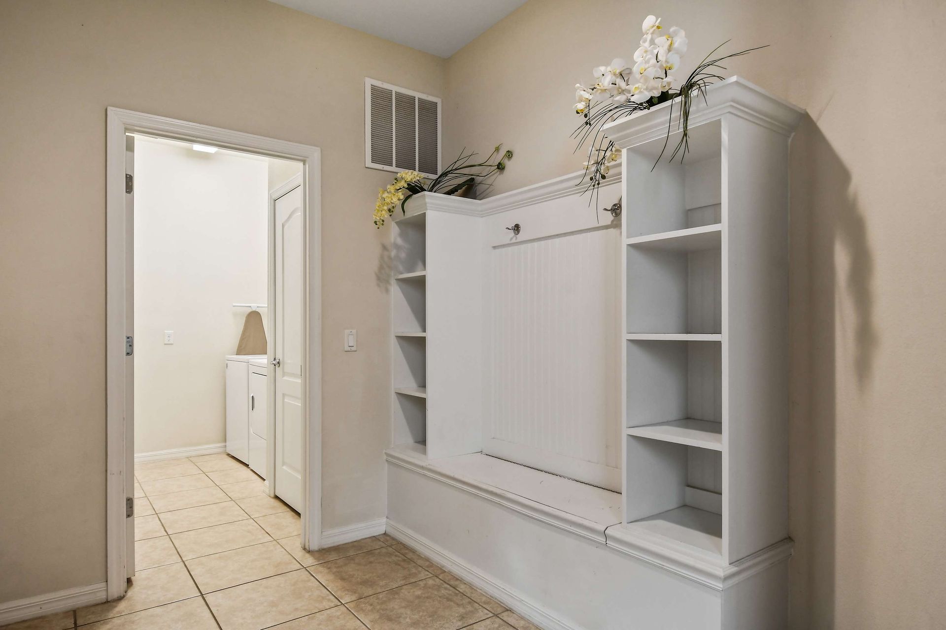 Spacious mudroom with built-in storage and easy access to the laundry room.