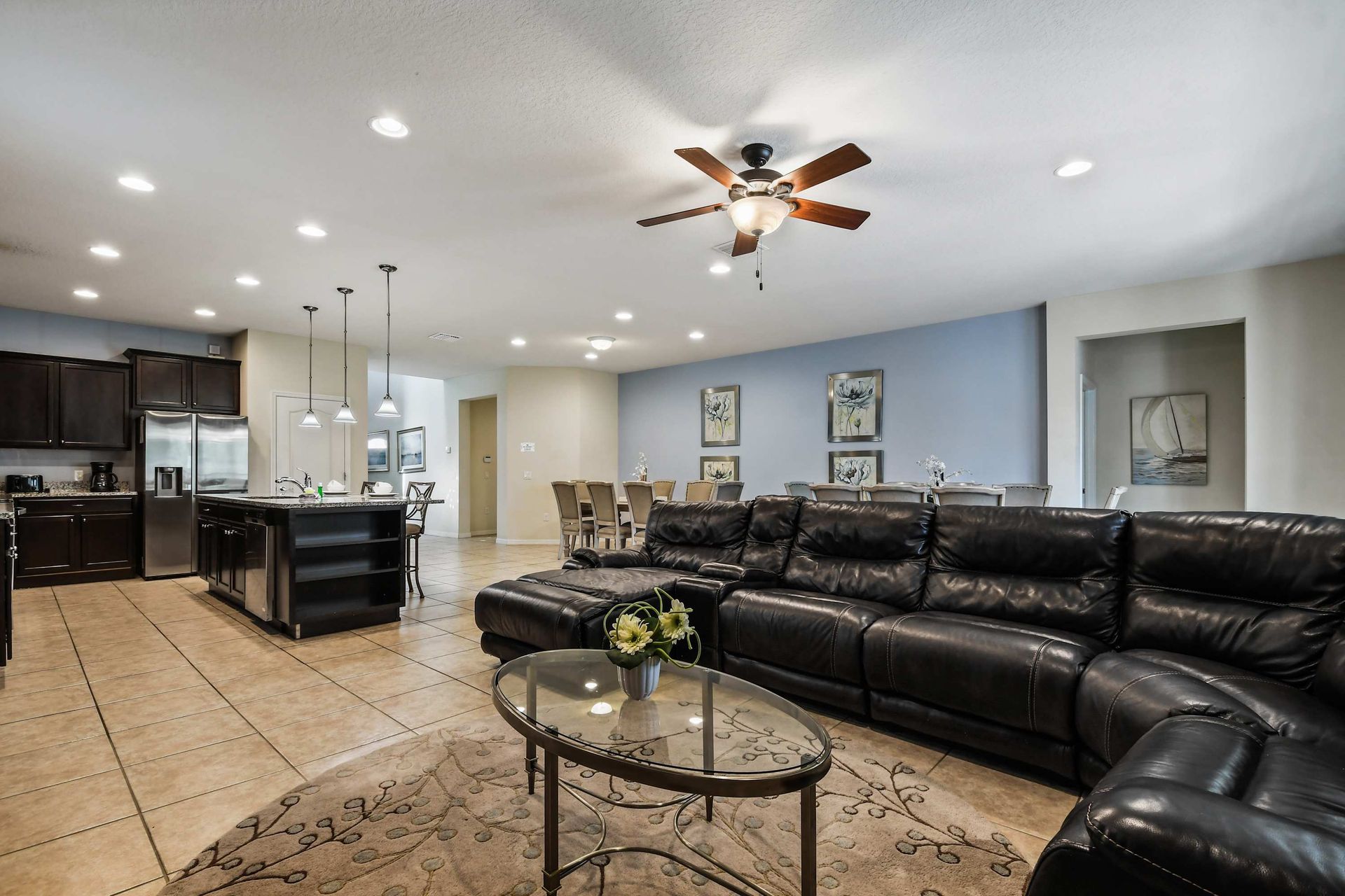 Open-concept living with plush seating, modern kitchen, and elegant dining area.