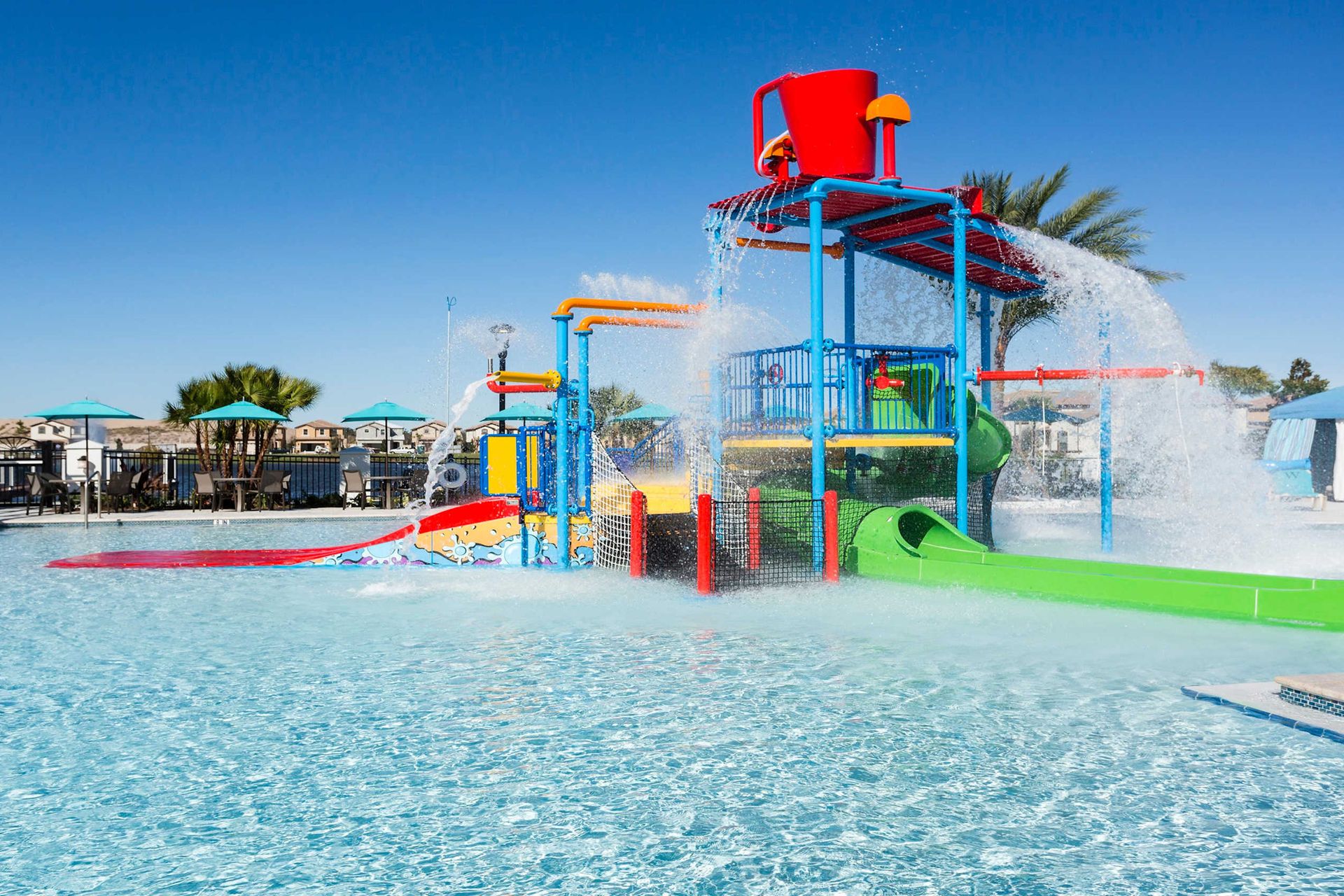 Crystal-clear pool with cabanas, lounge seating, and a fun splash zone!