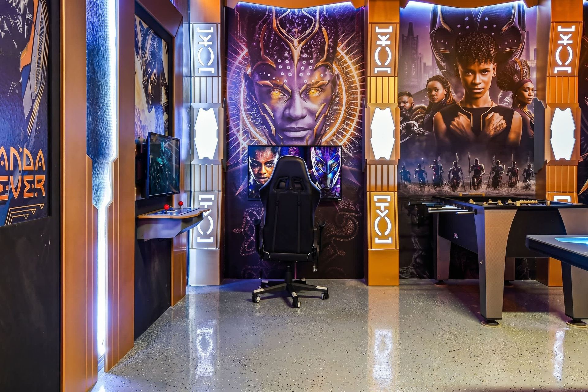 Epic Wakanda-themed game room with arcade, foosball, air hockey, and gaming chair.